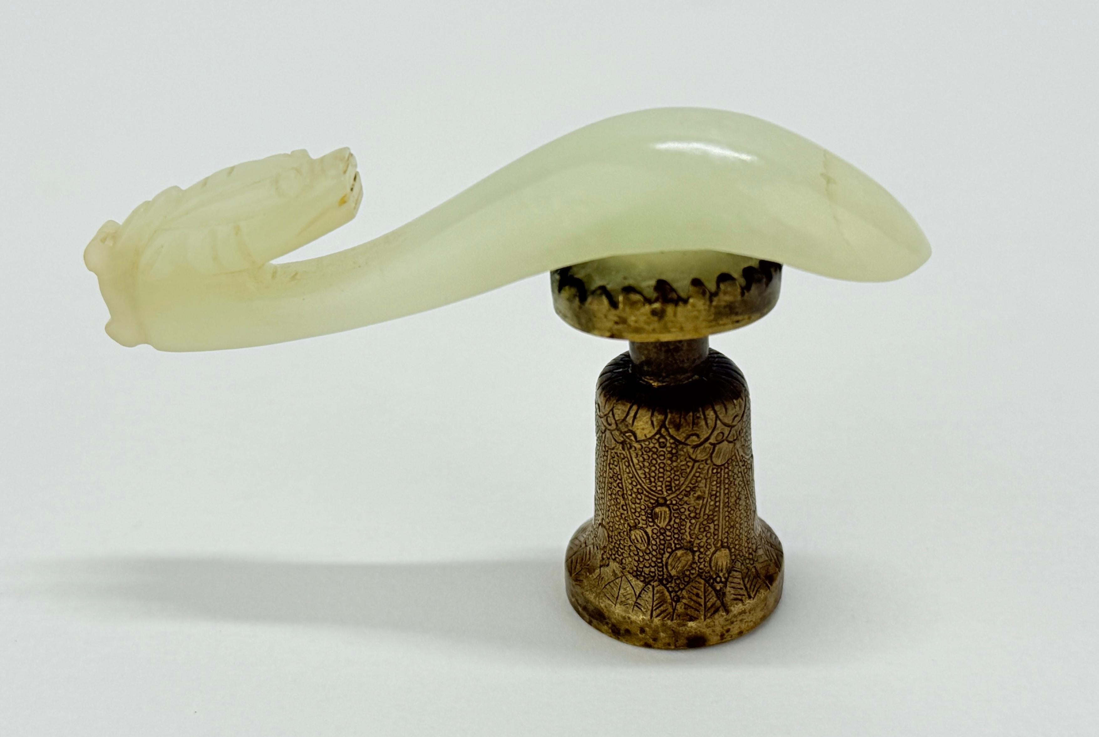 This exquisite antique Chinese Qing Dynasty belt hook showcases the fine craftsmanship and intricate artistry typical of the period. Carved from pale green jade, the piece features a dynamic dragon motif, symbolizing power, strength, and good