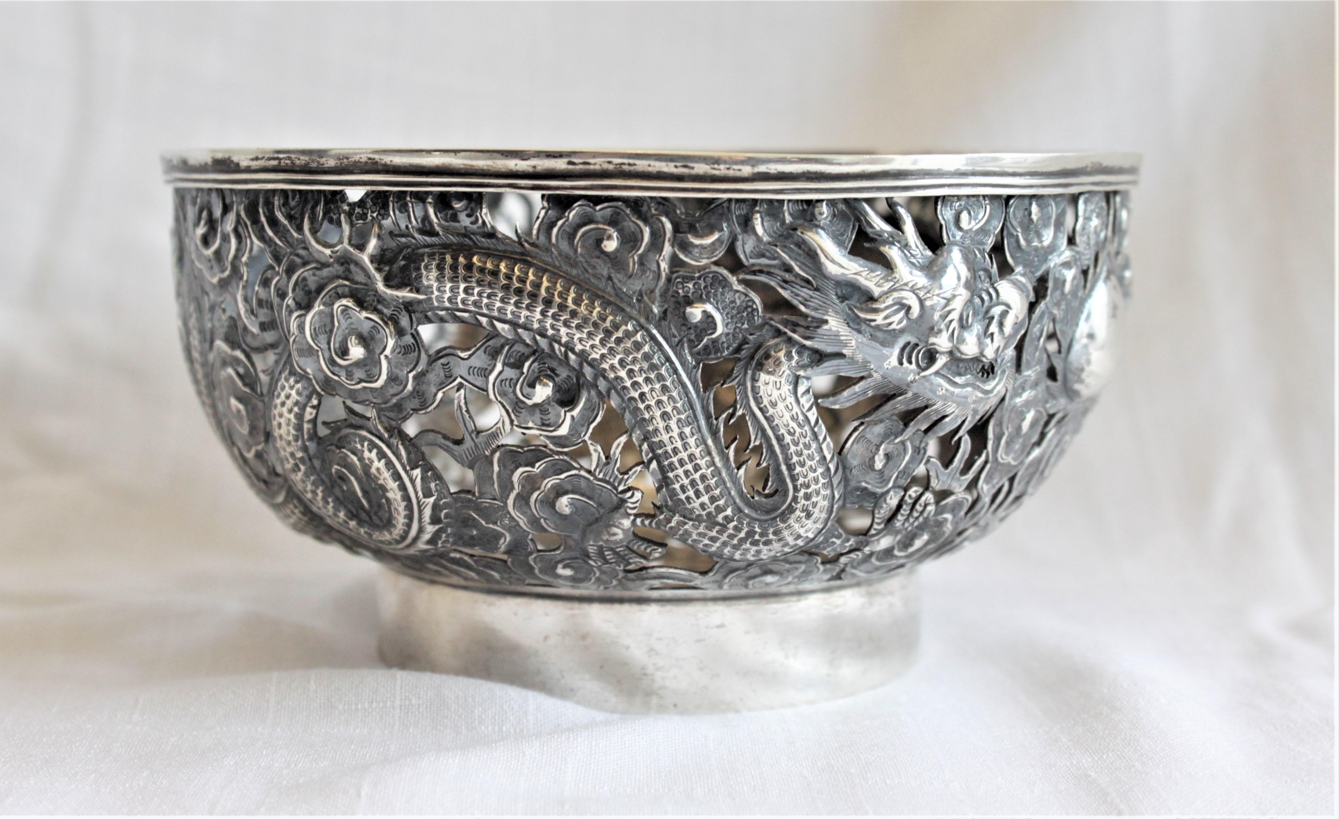This antique Chinese silver bowl was made during the Qing dynasty in approximately the year 1900 by the Wang Hing Company and is presumed to be sterling or .925 silver, but has not been tested. The sides of the bowl are done in extremely intricate
