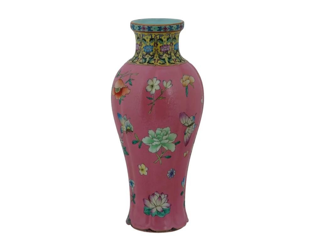An antique Chinese Qing Dynasty period QianLong Famille Rose porcelain vase. The baluster shape vase with a tall cylindrical body, wider slight ovoid, heavy on the shoulder, gently tapered gracefully toward slight tall cylindrical neck, flaring