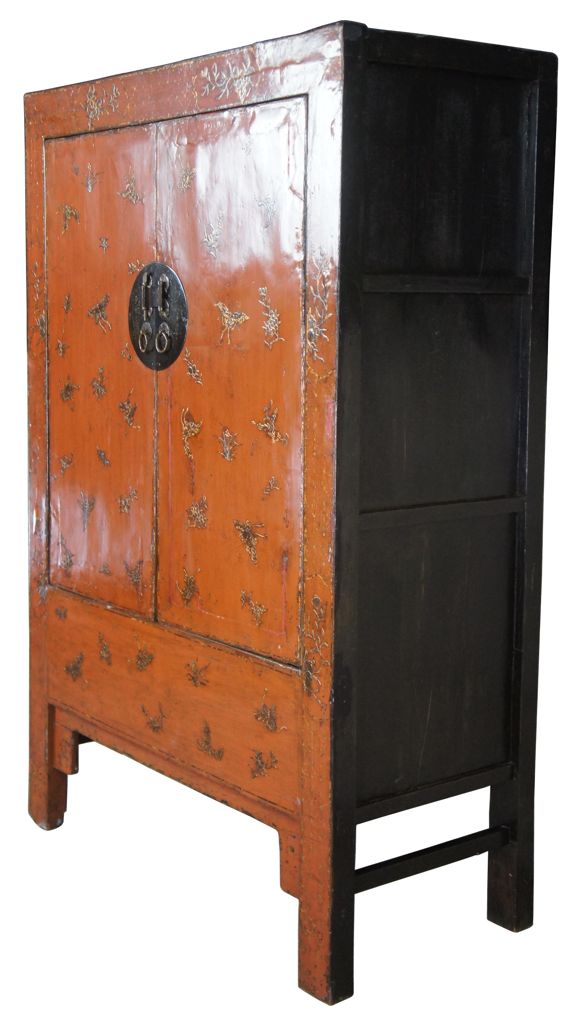 Antique 19th century Qing dynasty wedding cabinet. Made from elm with red lacquer finish over dragonfly / butterfly motif. Features two shelves and hidden interior compartment.
 