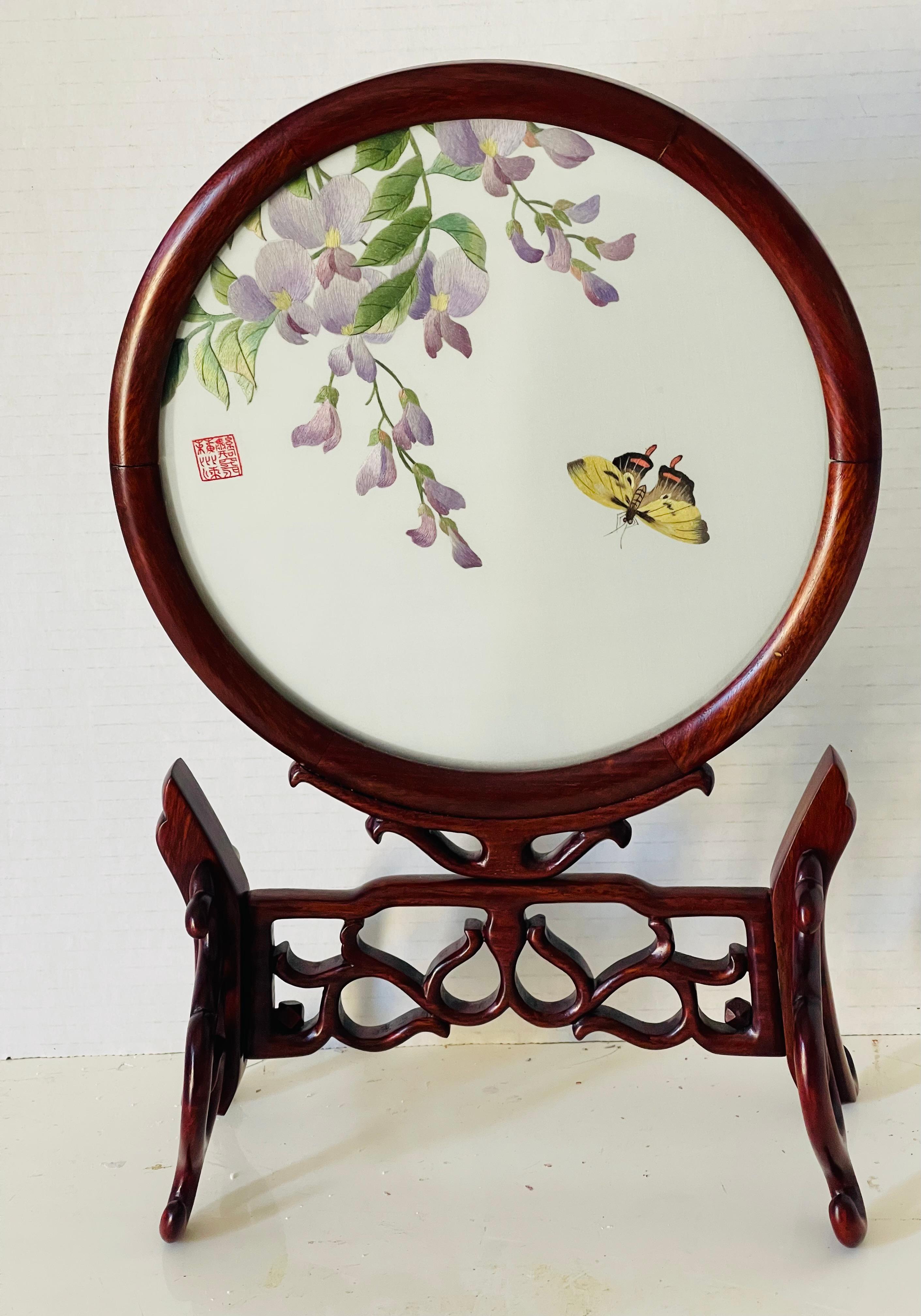 Antique Chinese Qing Dynasty embroidered silk on silk swear pea brunch with butterfly, framed in a hardwood round frame on carved table screen stand.. embroidered signature. Exceptionally elegant masterpiece.