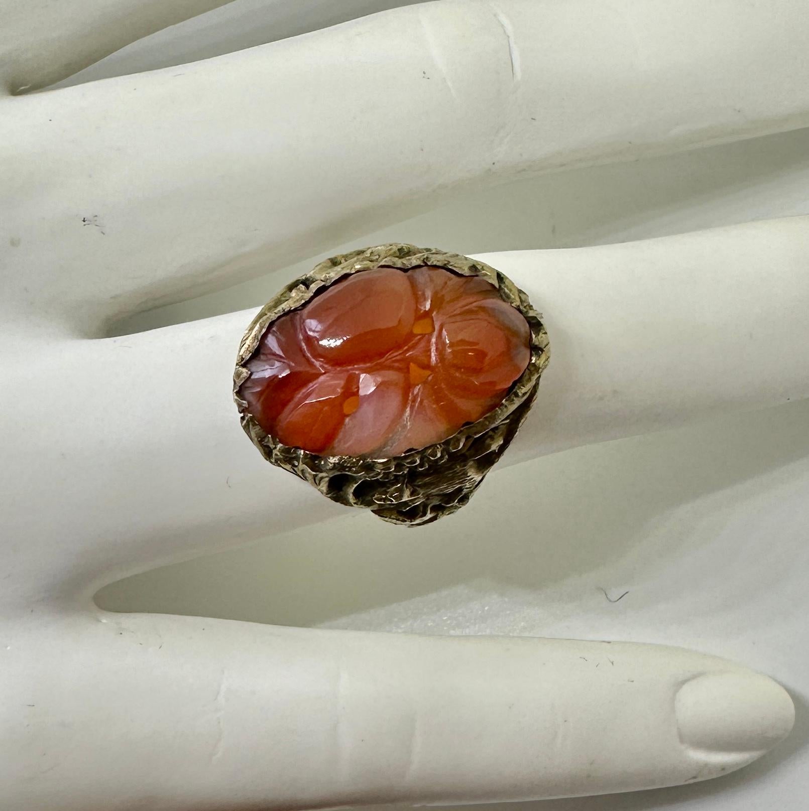 This is a wonderful and rare Chinese Rat Ring with a central carved Carnelian in a beautiful flower motif.  The silver gilt setting for the carnelian is extraordinary with a fantastic rat motif.  The rats crawling through the leaves and foliage are