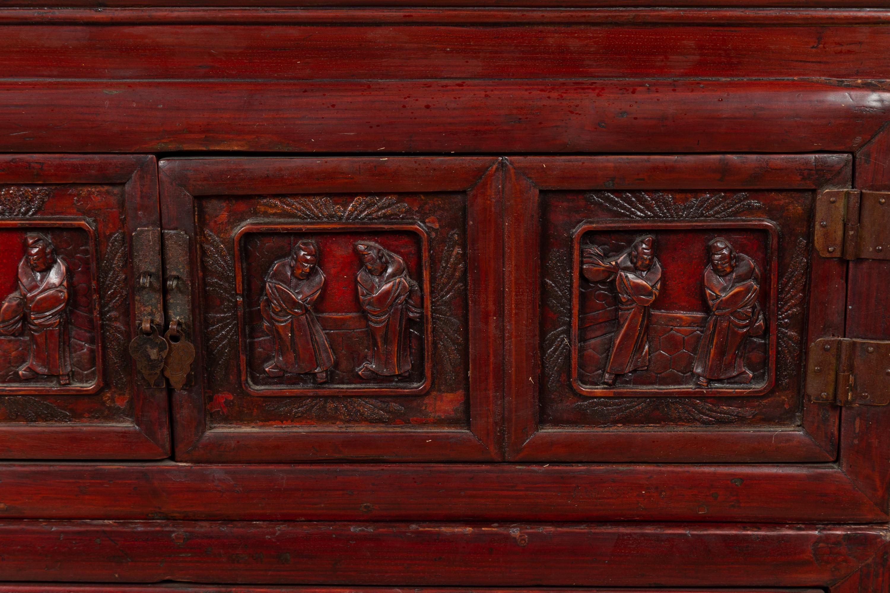 20th Century Antique Chinese Red and Black Lacquered Three-Section Chest with Carved Figures For Sale