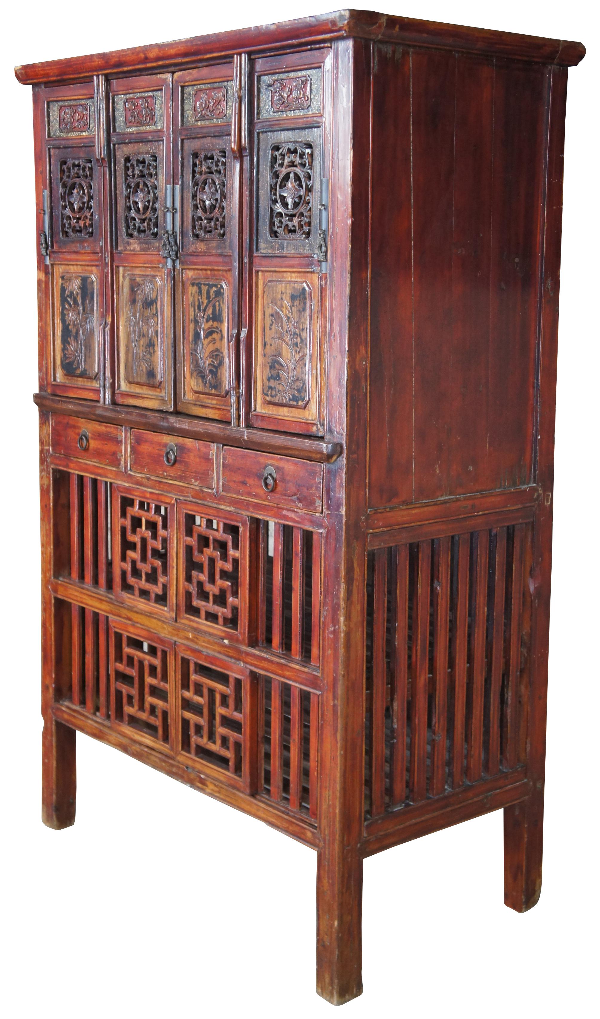 Antique Chinese Kitchen cabinet or cupboard. Made from Elm with intricate fretwork and finish in red, circa late 19th century. Features mortise and tenon joints, 3 drawers, adjustable lower panels and removable top doors.

Originally designed to