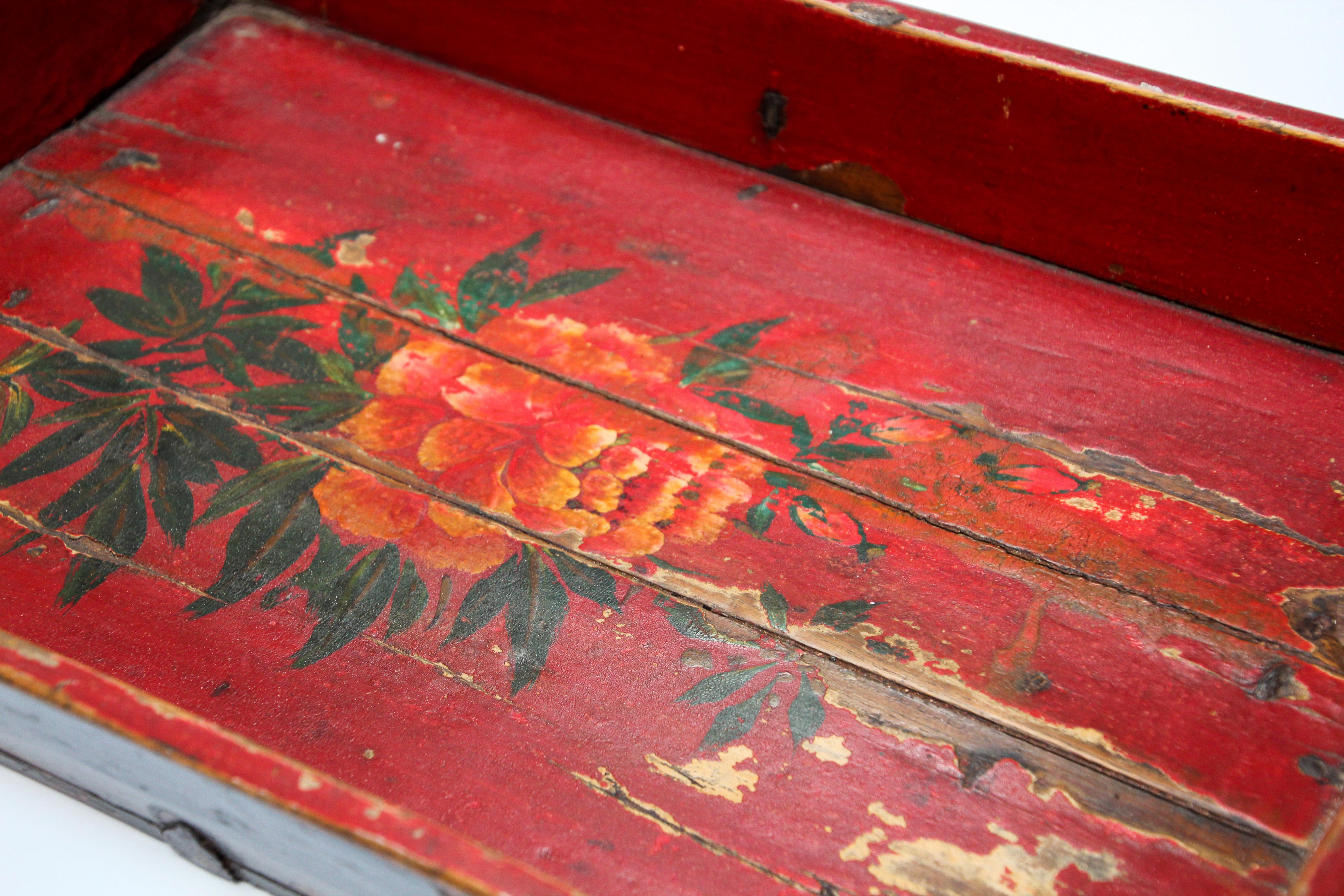 Late 19th century antique wood serving tray hand painted with flowers on red background.
Worn paint and great patina with floral painted design in red and yellow and green.
Well constructed and still strong and useful.
Lipped edges and wooden peg