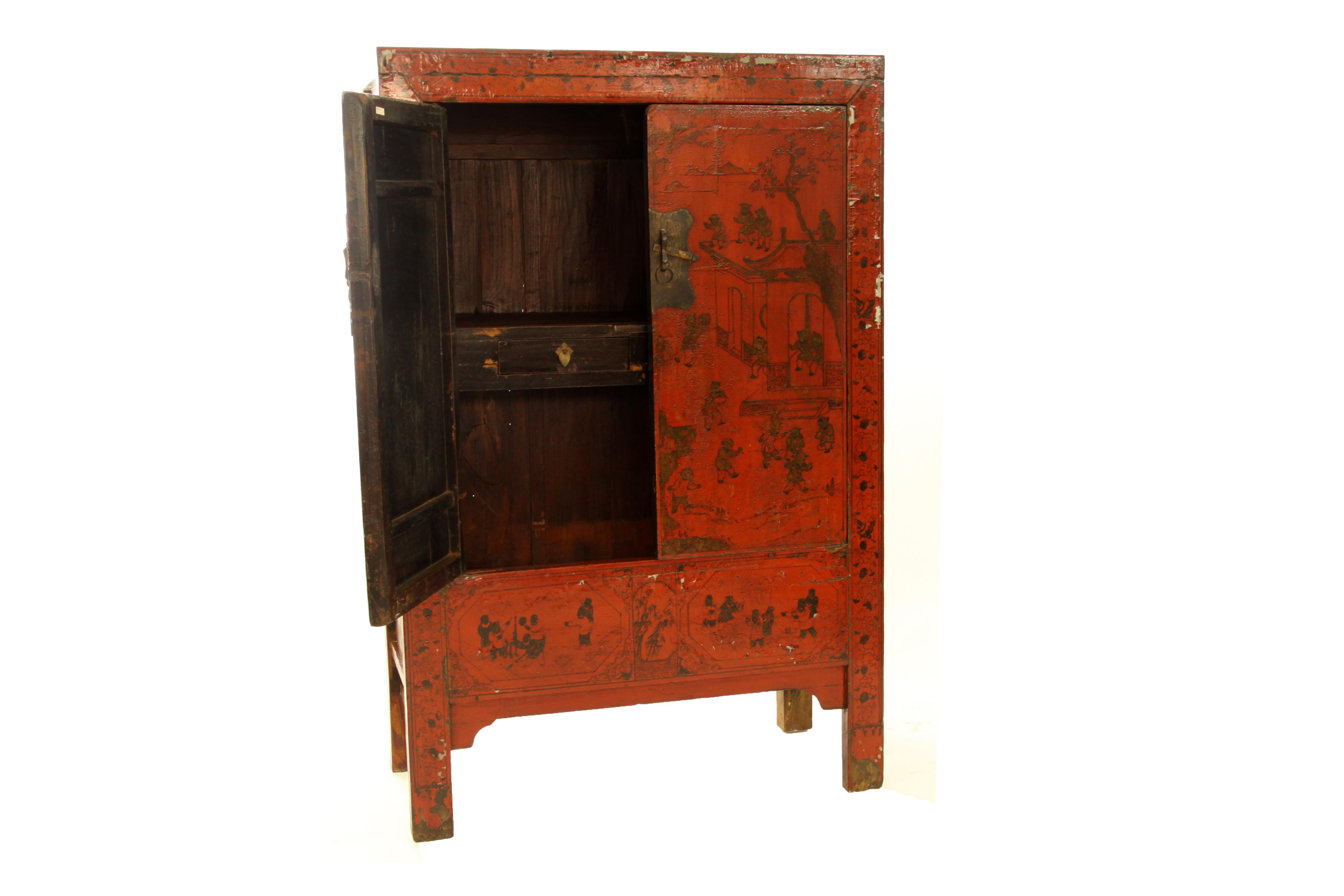 The fine gilt painted red lacquer cabinet with square top corners and rectangular-sectioned frames, a pair of paneled doors with gilt painting of children at play in the courtyard, opening to the interior with a mid-shelf forming the top of a row of