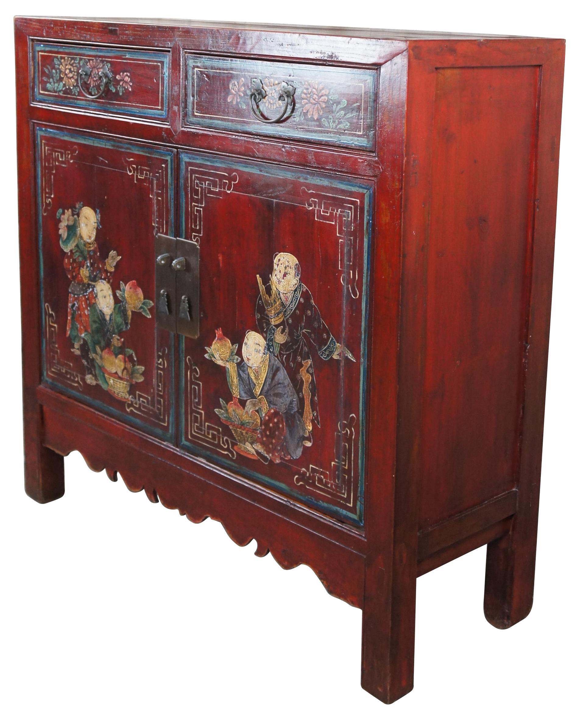 Impressive antique red lacquer Qing Dynasty cabinet. A rectangular form made from elm with mortise and tenon construction and lower serpentine carved apron. Features two dovetailed drawers over lower cabinet with shelf. Each cabinet drawer and door