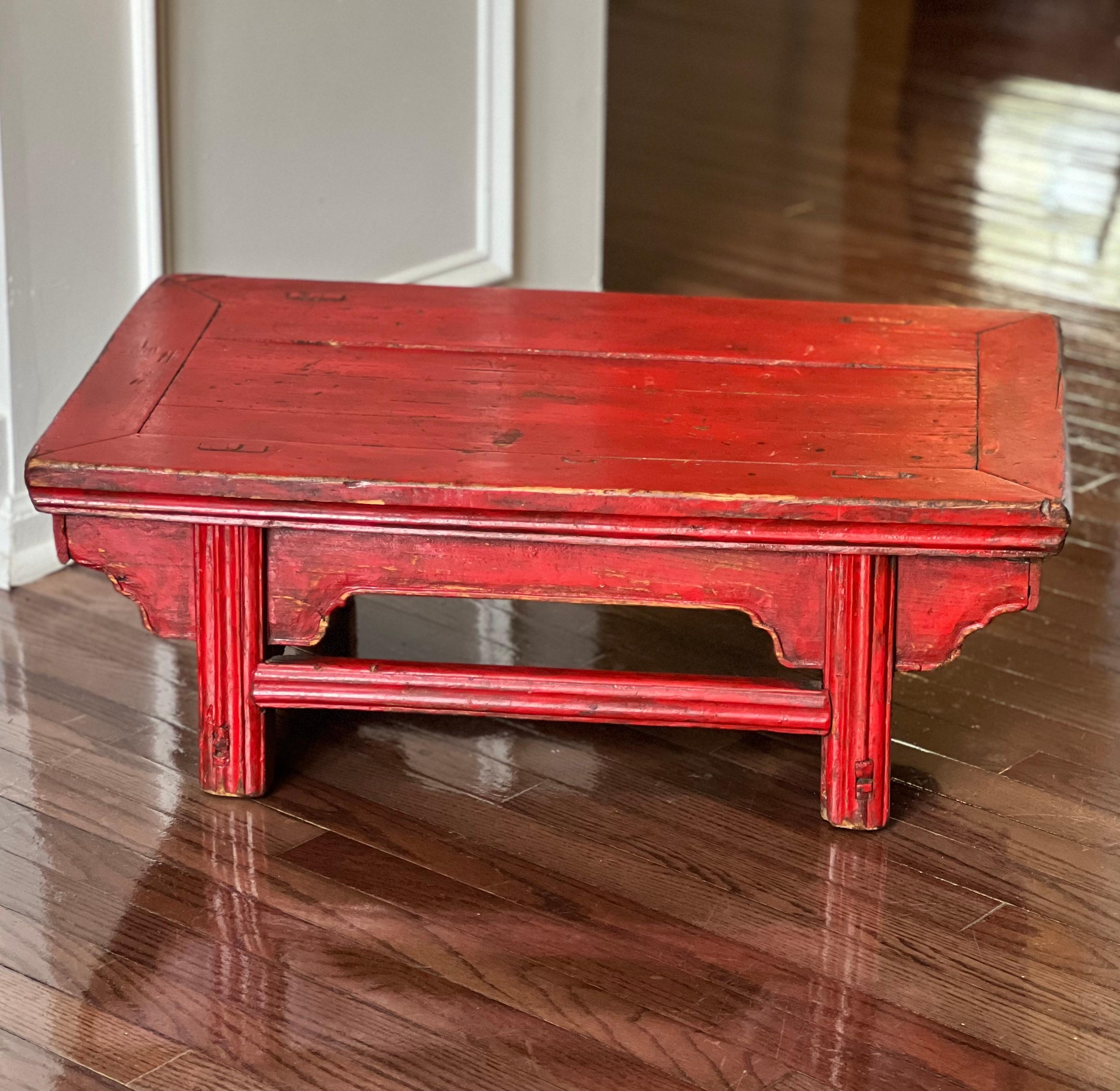 Antique Chinese red lacquer low Kang table, c. 1910's.

The Kang table has a rich history as it was used in everyday life for dining, having tea, playing games and meditation. The table features classic mortise and tenon joinery ensuring both