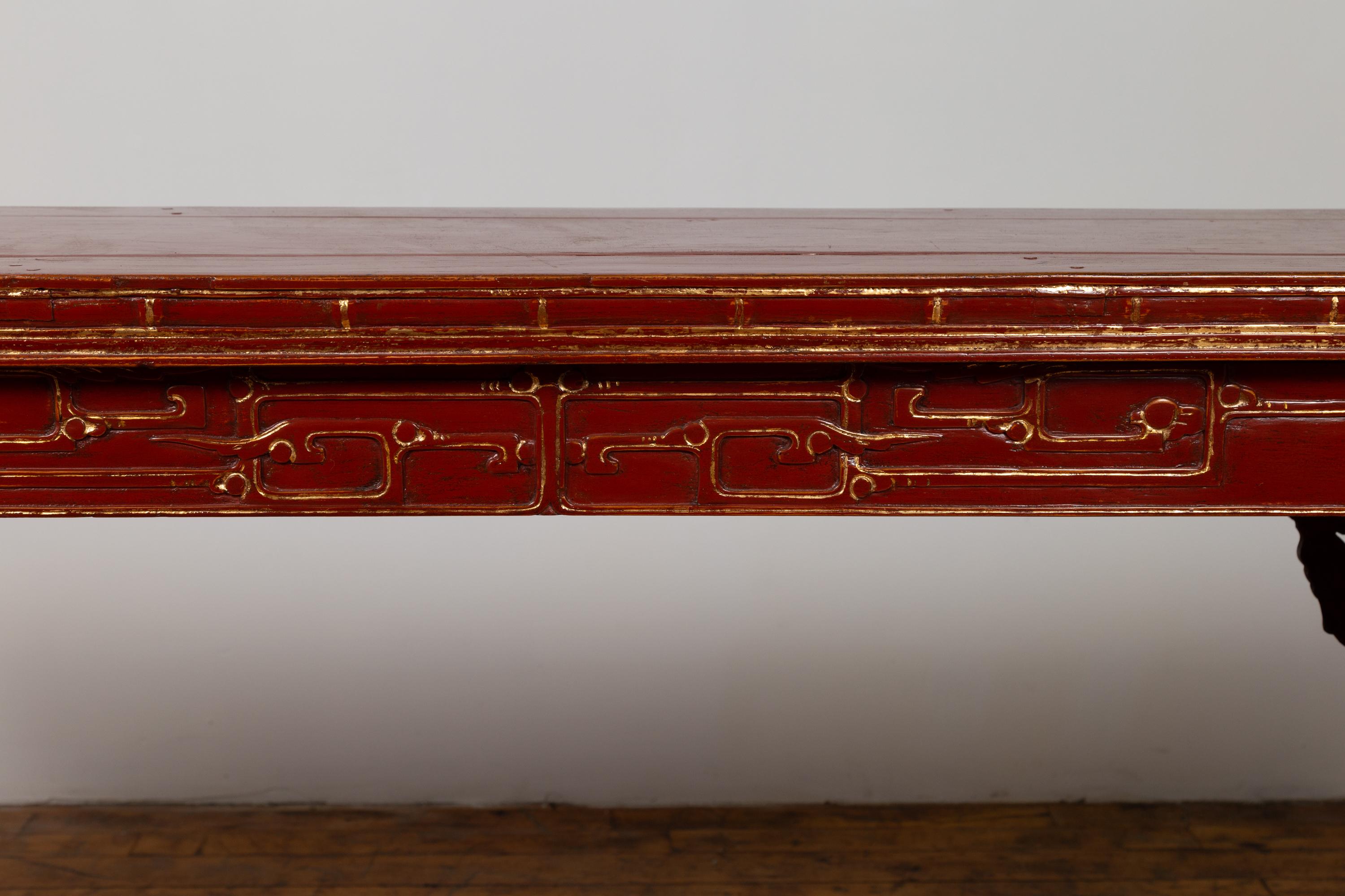Wood Antique Chinese Red Lacquered Console Table with Gilt Accents and Carved Apron For Sale