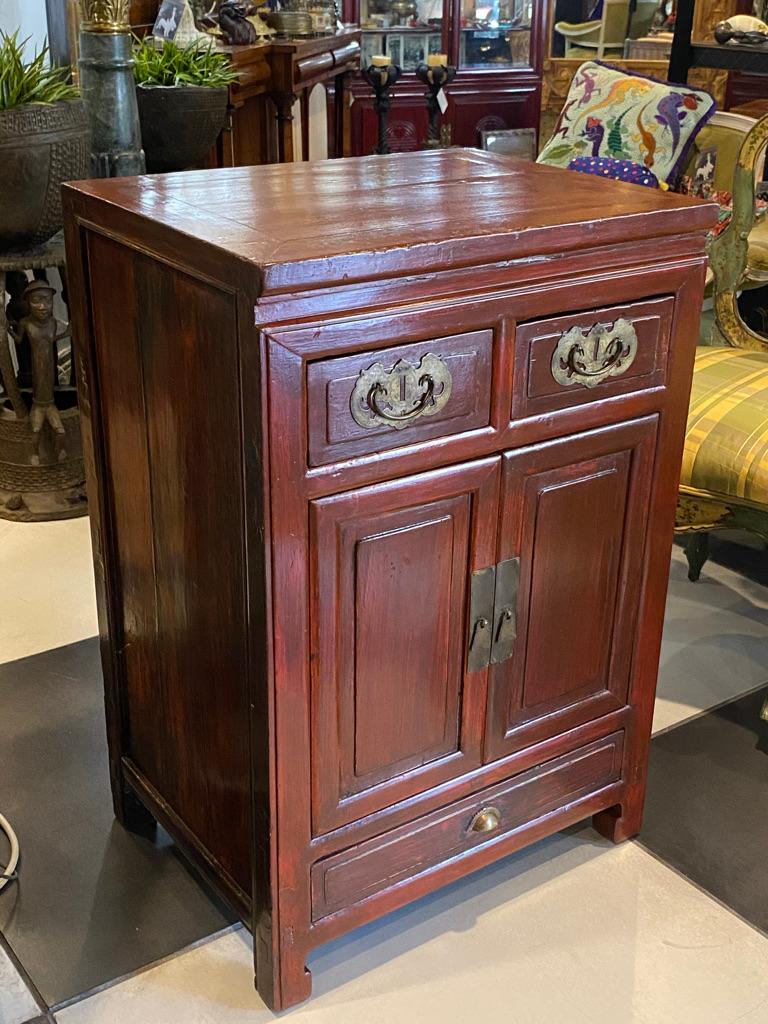 This is the nicest hat cabinet I have seen in the long time, red lacquered to the best finish one long drawer to the bottom, a pair of doors with a shelf inside and two drawers side by side to the top. All having brass pulls.