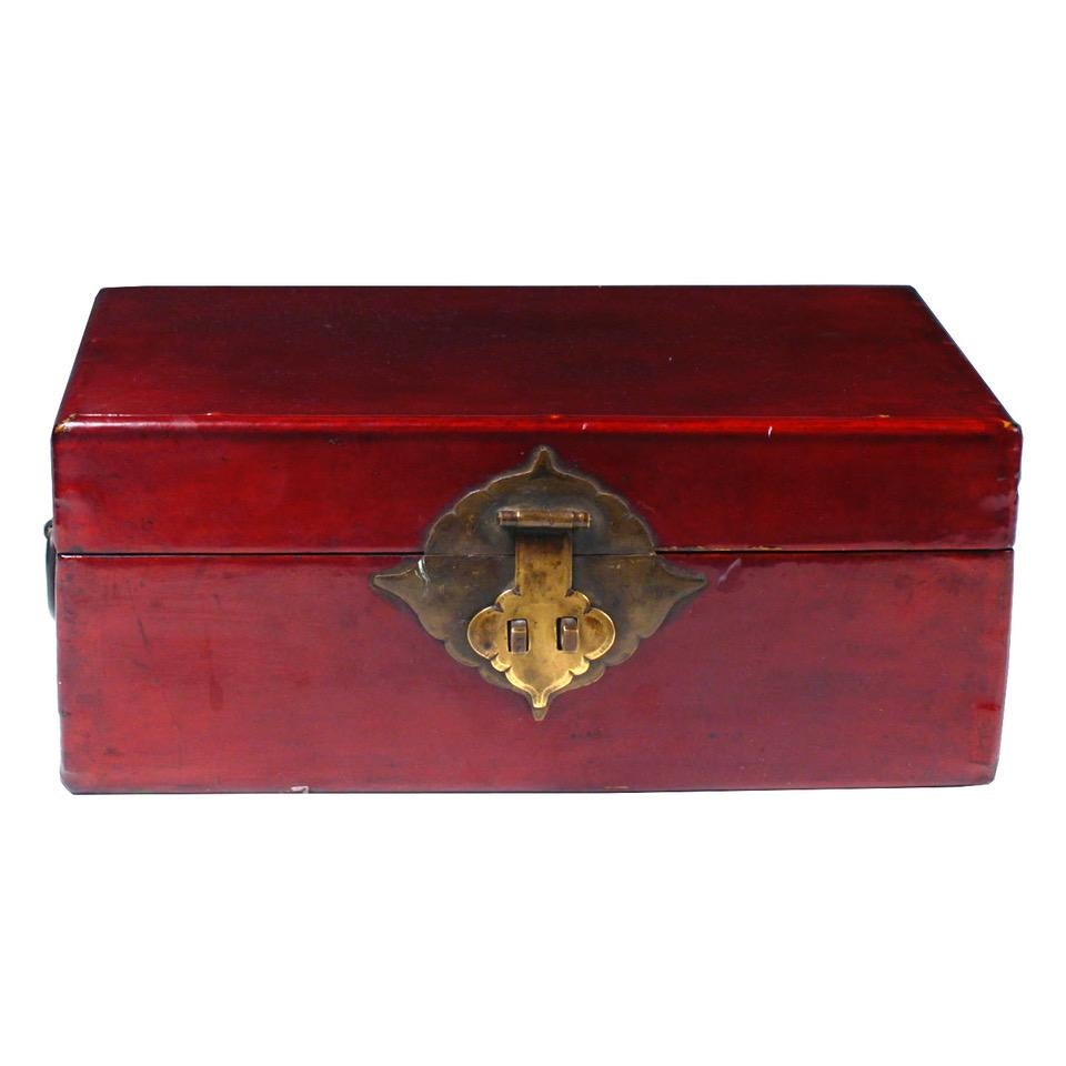 Chinese document box, the wood box covered in pig skin which has been tanned, stitched and lacquered in a rich translucent red color, overall simple rectangular form, the cover hinged with a set rectangular shaped brass hinges to the box, the front