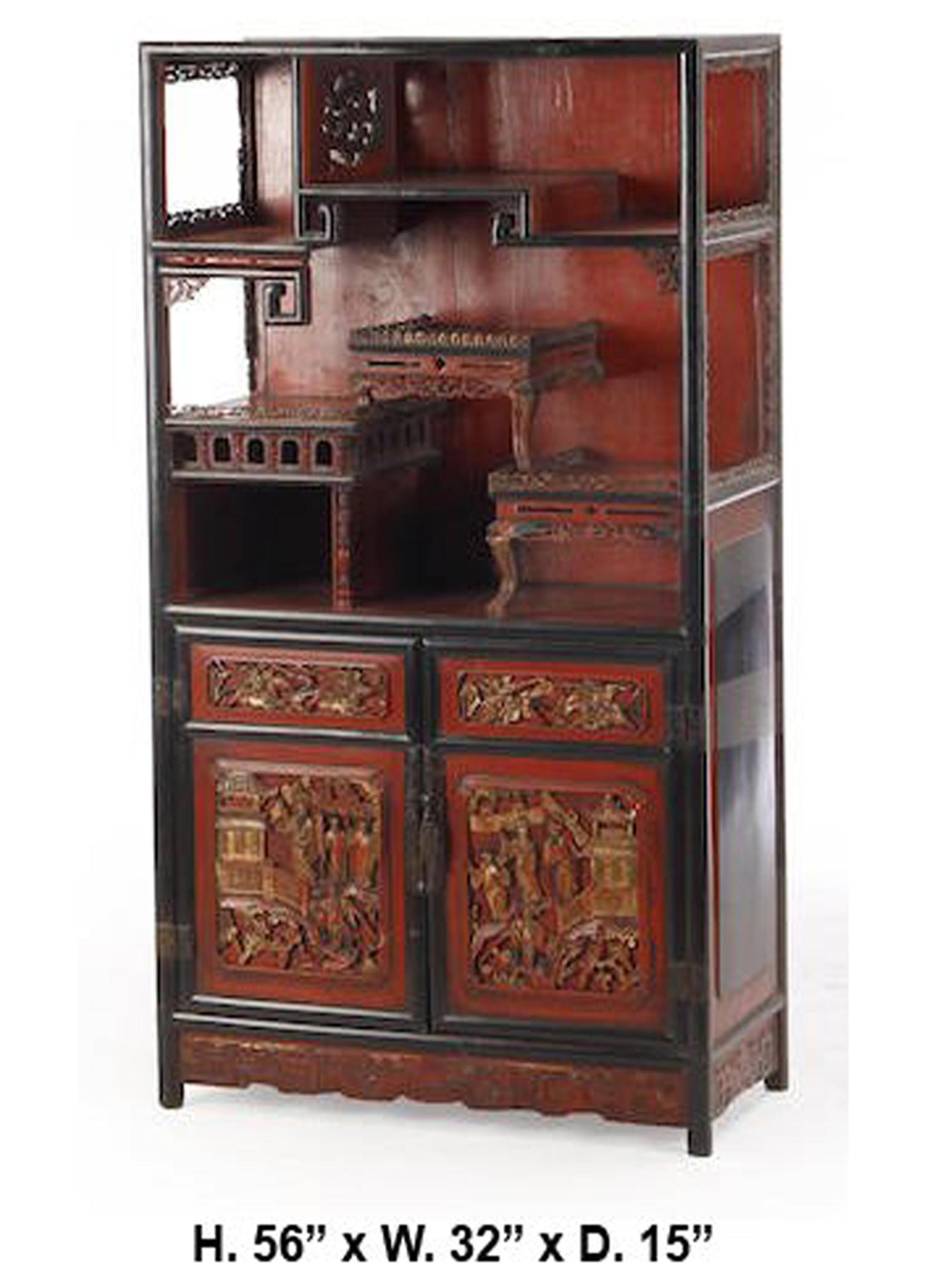 Antique Chinese red paint decorated and lacquered parcel-gilt carved wood cabinet.
First half of the 20th century.

The red painted top half fitted with shelves and pigeon holes, above two red and black lacquered doors with parcel gilt panels