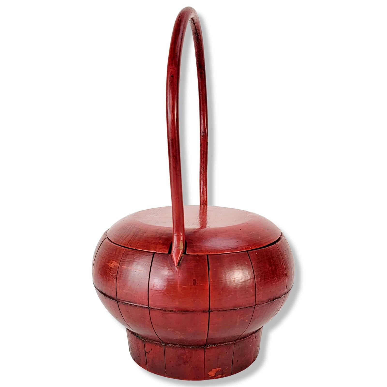 An elegant antique basket from southern China. Such a basket was used in the 19th century China to store and carry auspicious fruits and foods for weddings. Red lacquer symbolizes good luck and great fortune. Choice wood panels were hand cut and