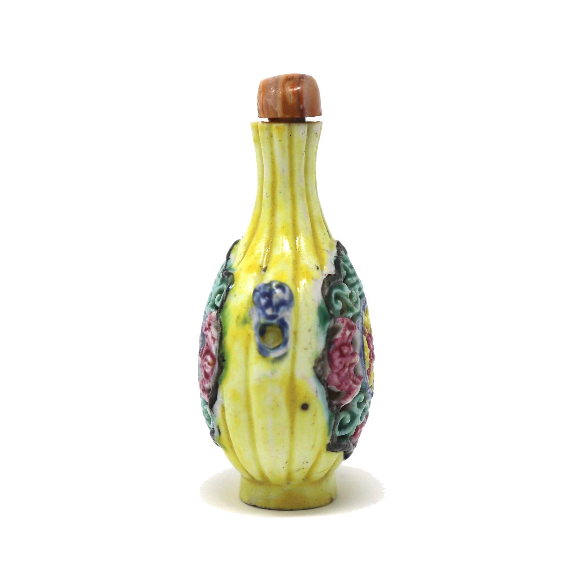 Antique Chinese reticulated soft paste porcelain snuff bottle, ribbed and rounded vase form with a long flared neck, flat mouth, narrow aperture, animal mask handles at the opposing shoulders, raised oval foot rim with a countersunk base, moulded