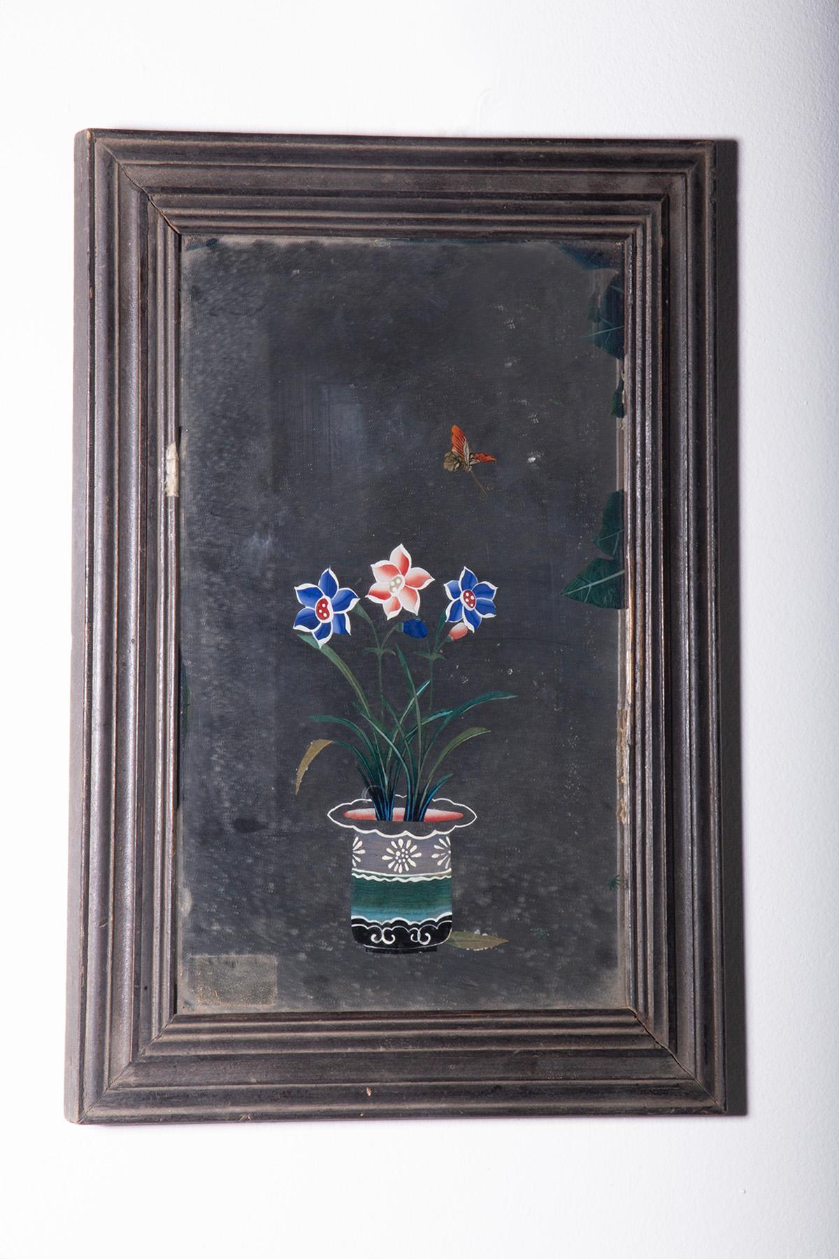 Fascinating 19th-century Chinese mirror painting depicting traditional Chinese interiors with flowers in vases placed on wooden stands, bonsai trees in ceramic planters, books, and other details reminiscent of the artistic culture of the time. This