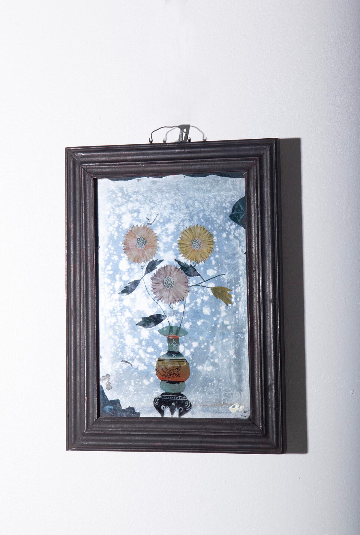 Fascinating 19th-century Chinese mirror painting depicting traditional Chinese interiors with flowers in vases placed on wooden stands, bonsai trees in ceramic planters, books, and other details reminiscent of the artistic culture of the time. This