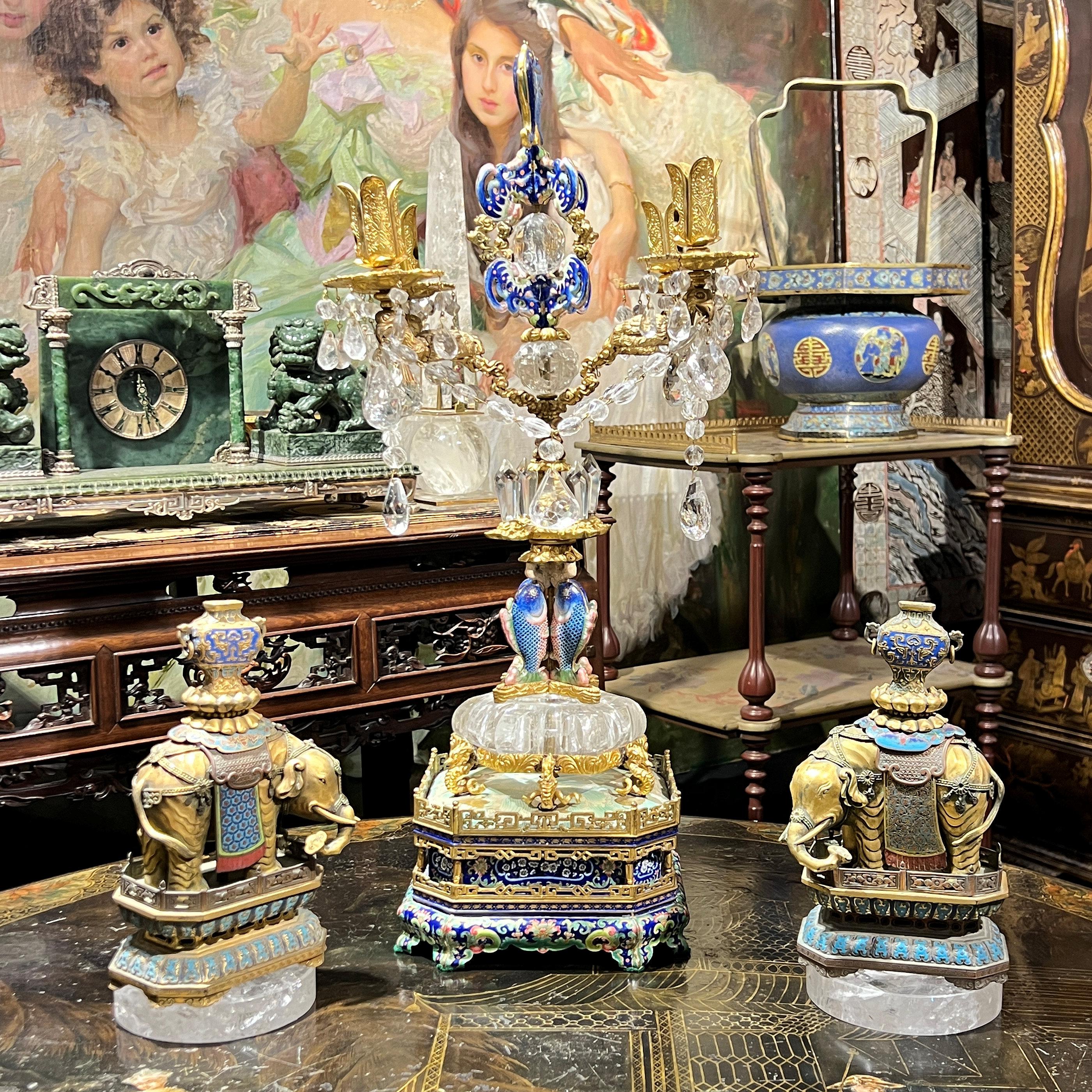 Our extraordinary Chinese candelabrum dates from as early as the 18th century with later 19th century additions is exquisitely crafted from rock crystal and gilt metal with enamel designs including fish and bats, with four candle arms and a square