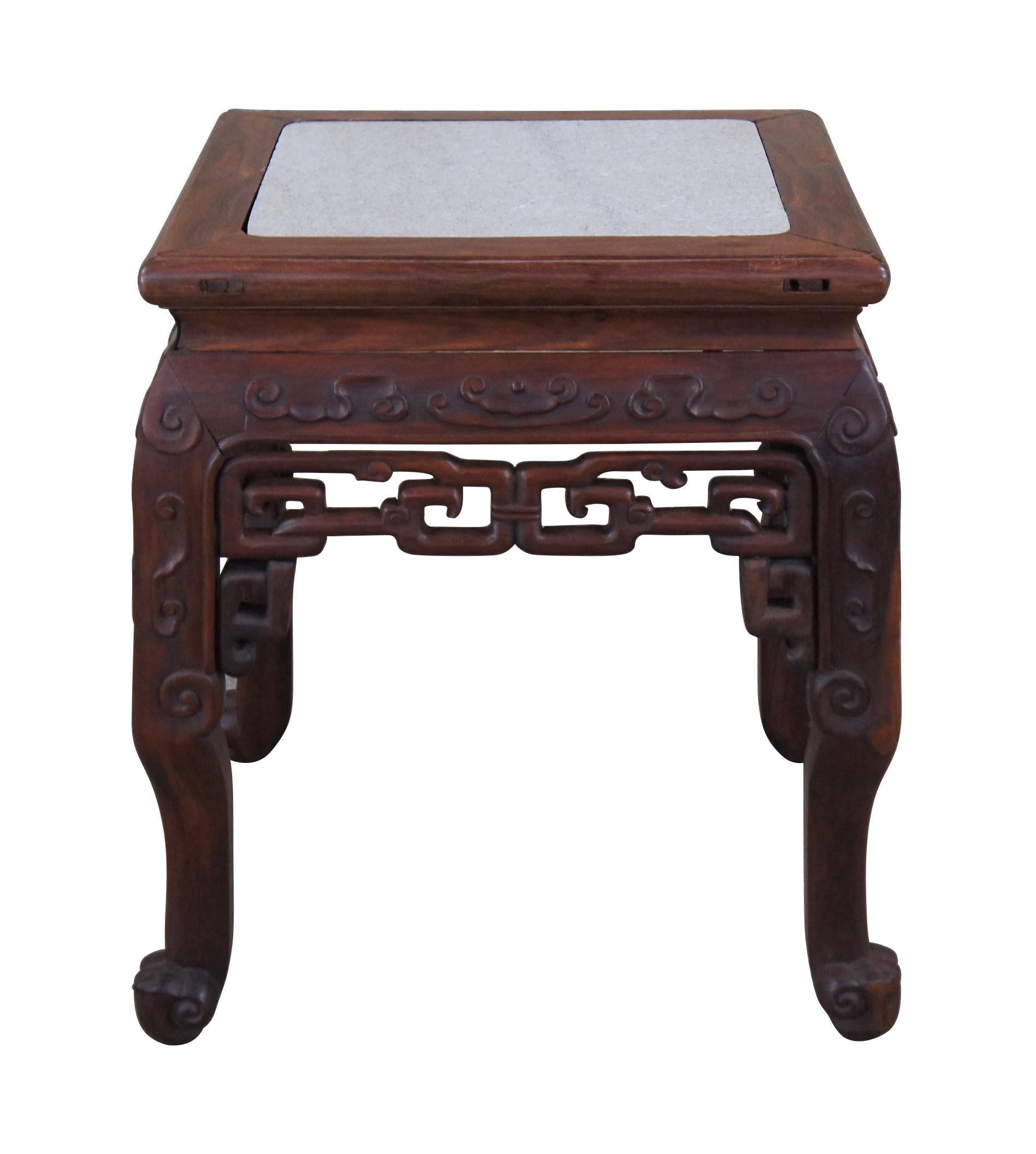 An impressive early 20th century rosewood table or stand.  Features a beautiful hardwood frame with inset marble top, low relief carvings and pierced scrolling spandrels.  A versatile piece that works well as a side table, stool, sculpture
