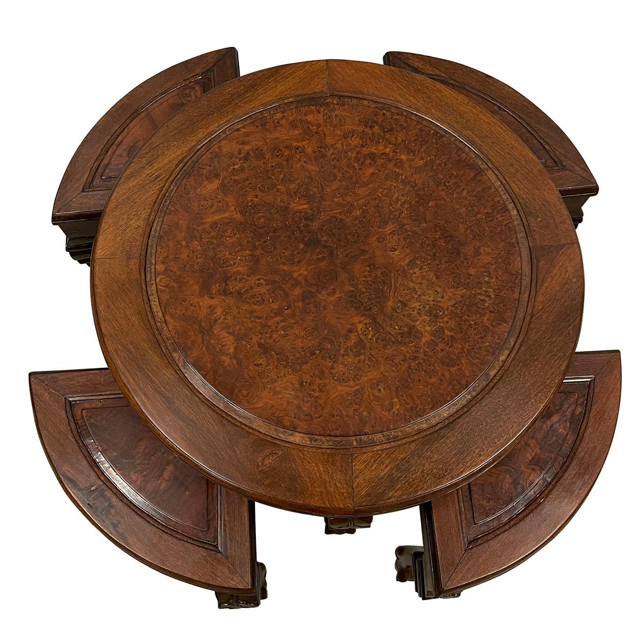 This beautiful carved coffee table from the 1900s is made from solid rosewood and showcases the beautiful details of burl wood on its top surface. Traditional Chinese carvings flow all around the sides and down its “tiger legs.” In addition, there