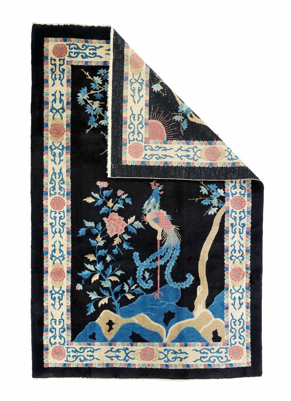 Antique Chinese Rug 5'2'' x 7'10''. The cream open field is centred by a landscape vignette featuring a mythical animal amid rock, clouds and sparse vegetation. Each corner shows a two-story building and a bent tree. Medium blue border of precious