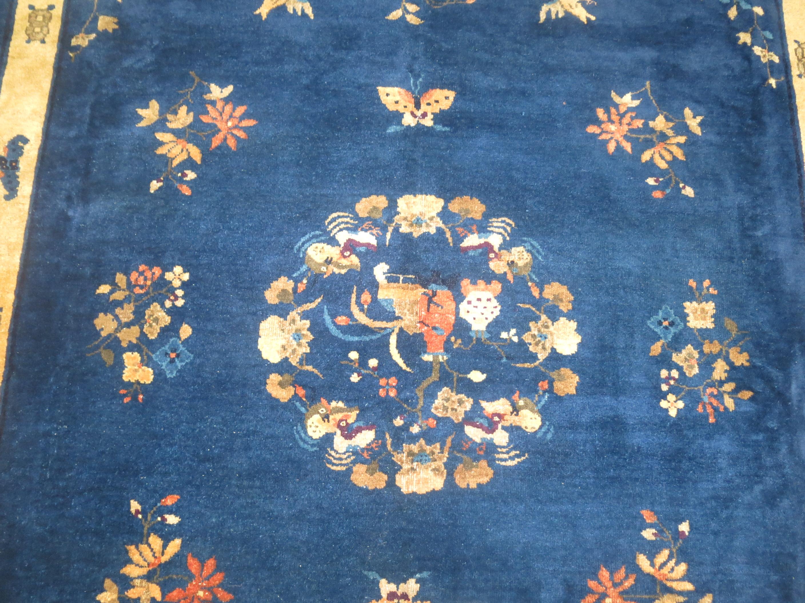 A room size full pile Chinese Art Deco rug in predominant blues and ivory.