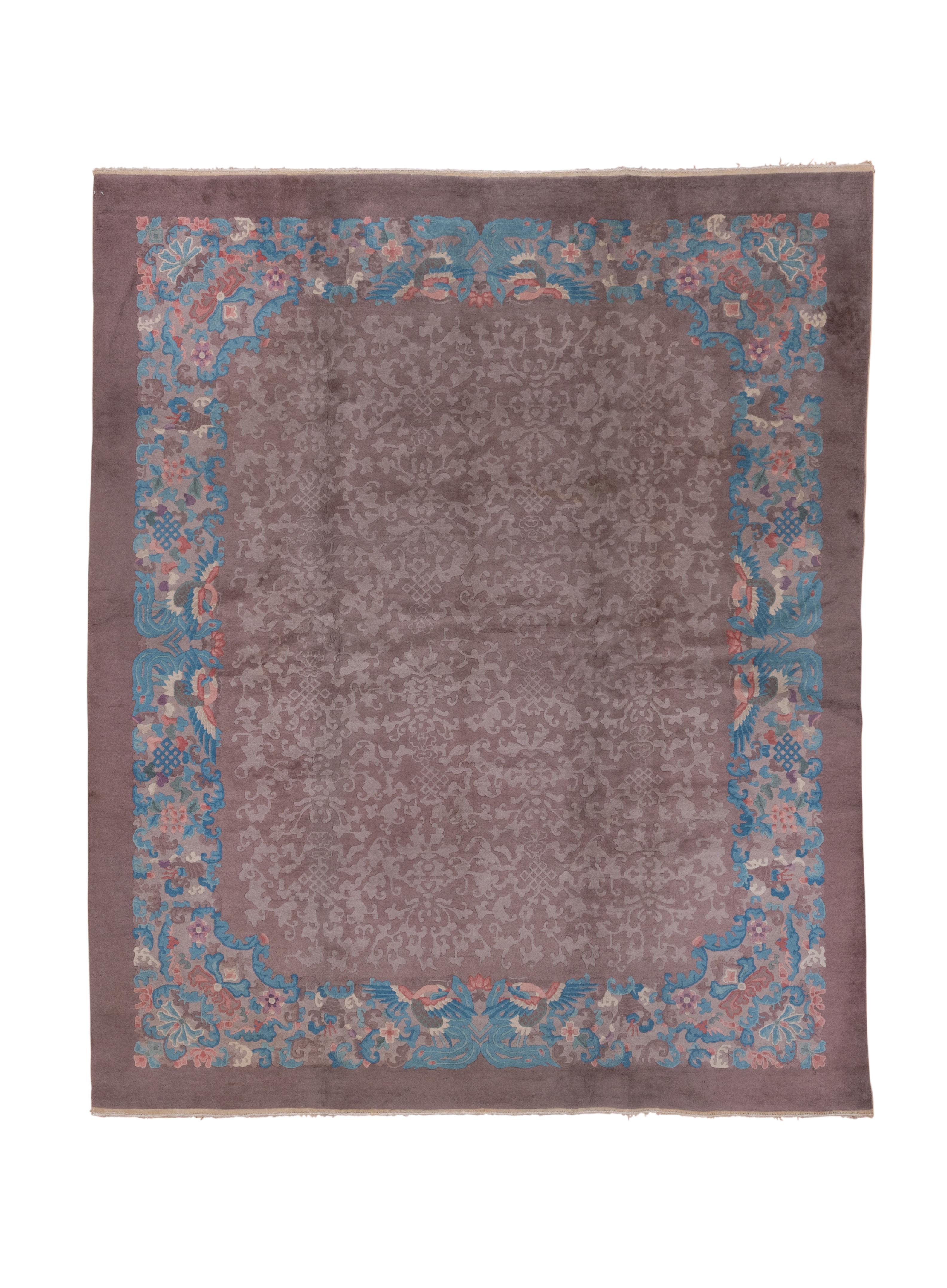 The buff-putty field shows an allover leaf, blossom, knot and cloud band, relaxed tone-on-tone, well contour cut, pattern, within a light blue border of phoenixes, knots and palmettes. Cartouche-shaped field is a Fette trademark. Plain outer coral