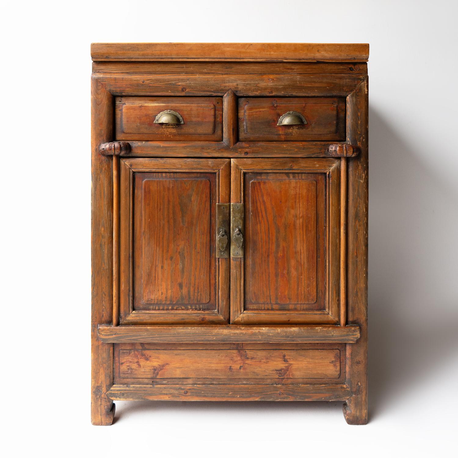 Antique Cabinet
A handsome Provincial Chinese side cabinet which would have originally been used to hold tea-related items and to use the top to serve tea to guests.

Made from solid elm which has then naturally worn from use over time.

Two drawers