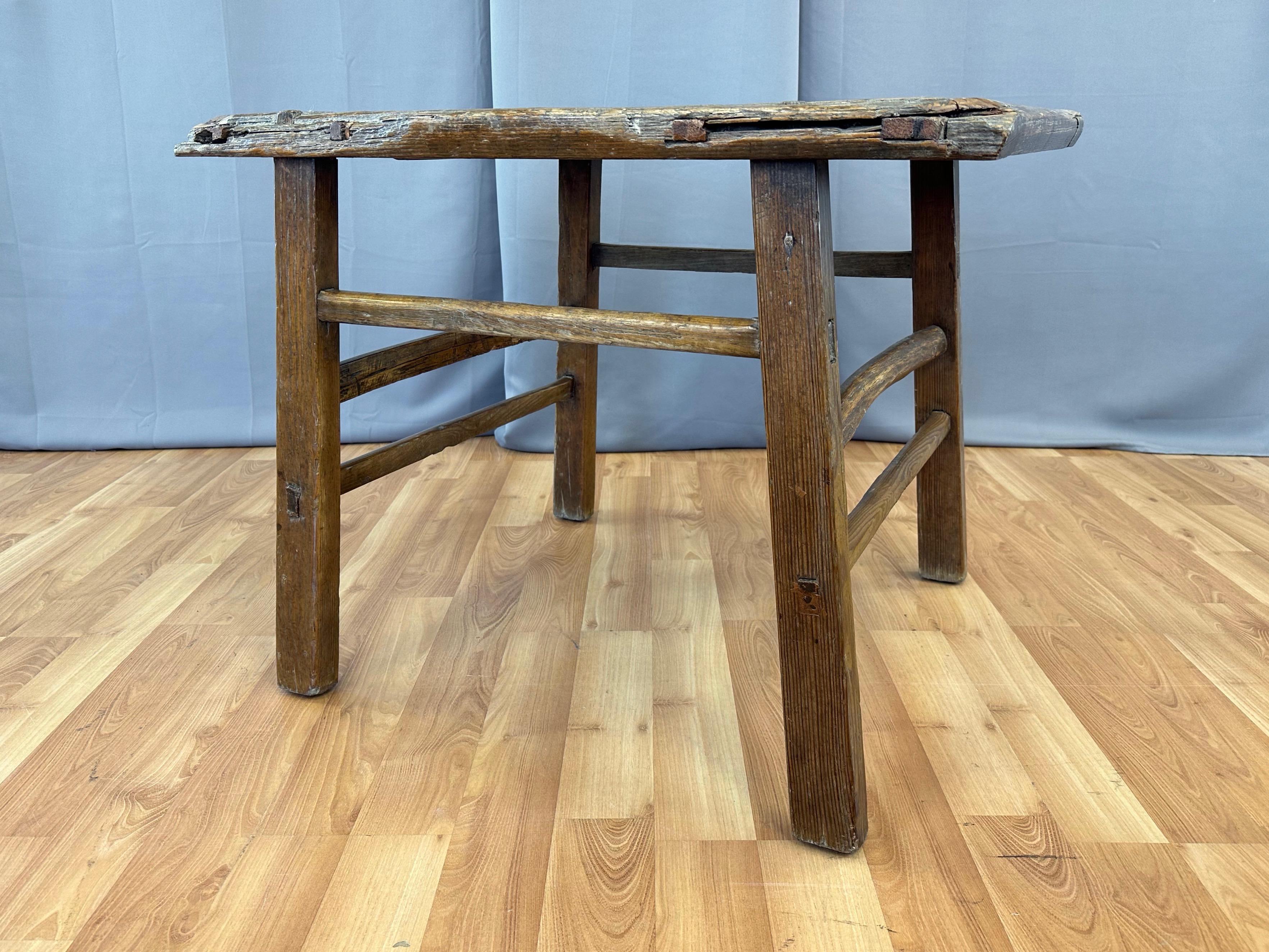 A circa 1875 Chinese Qing period rustic elm wood altar table or work table, most likely from Shanxi province.

Solid elm wood construction displays hard-earned and authentic antique character from top to bottom. Features an especially handsome and