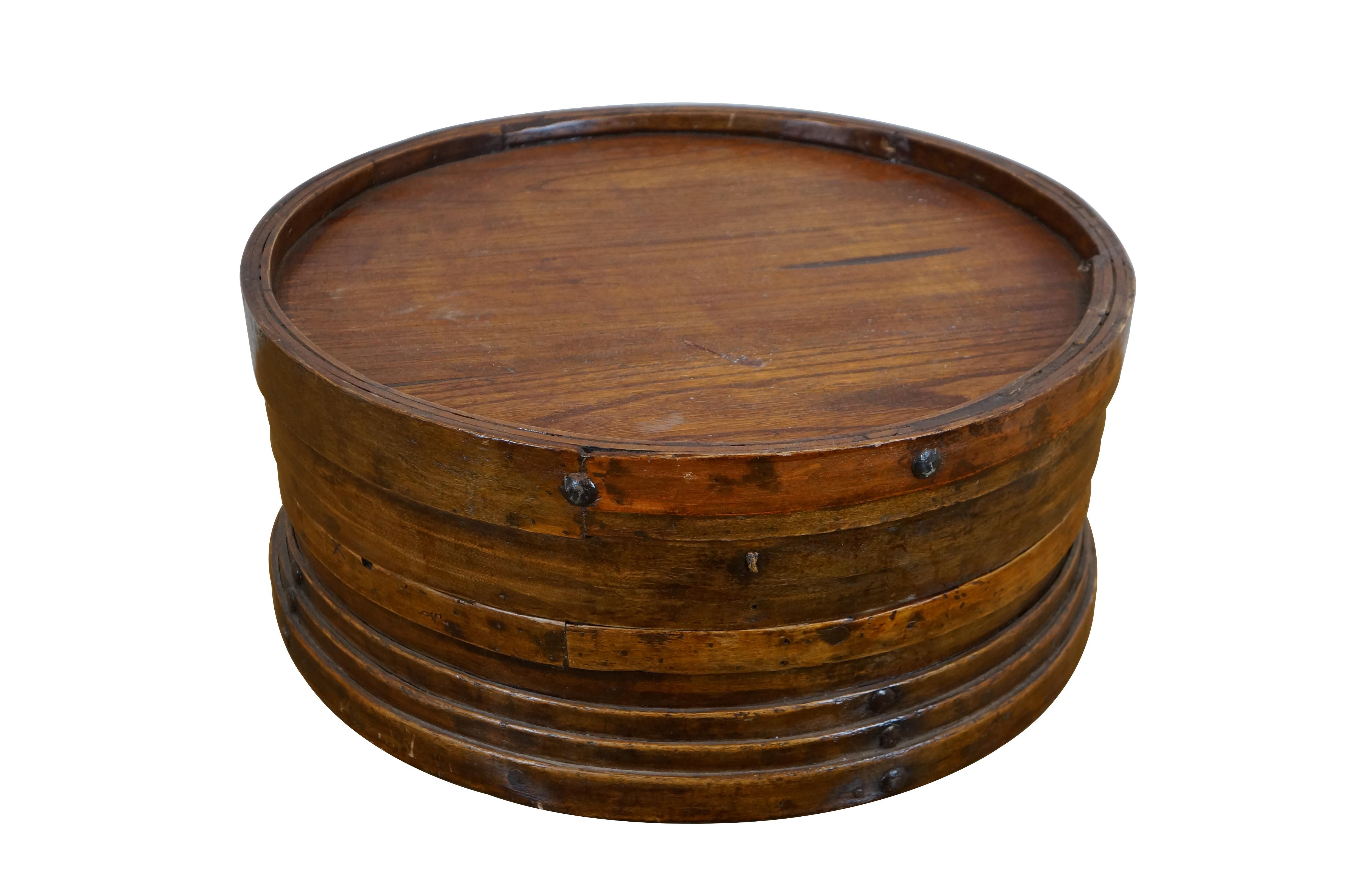 Early 20th century Shanxi wooden storage box used for serving steamed dumplings / food at family gatherings.  This steamer box features traditional round, rustic, bentwood construction with metal nails / rivets. 

Dimensions:
19.75
