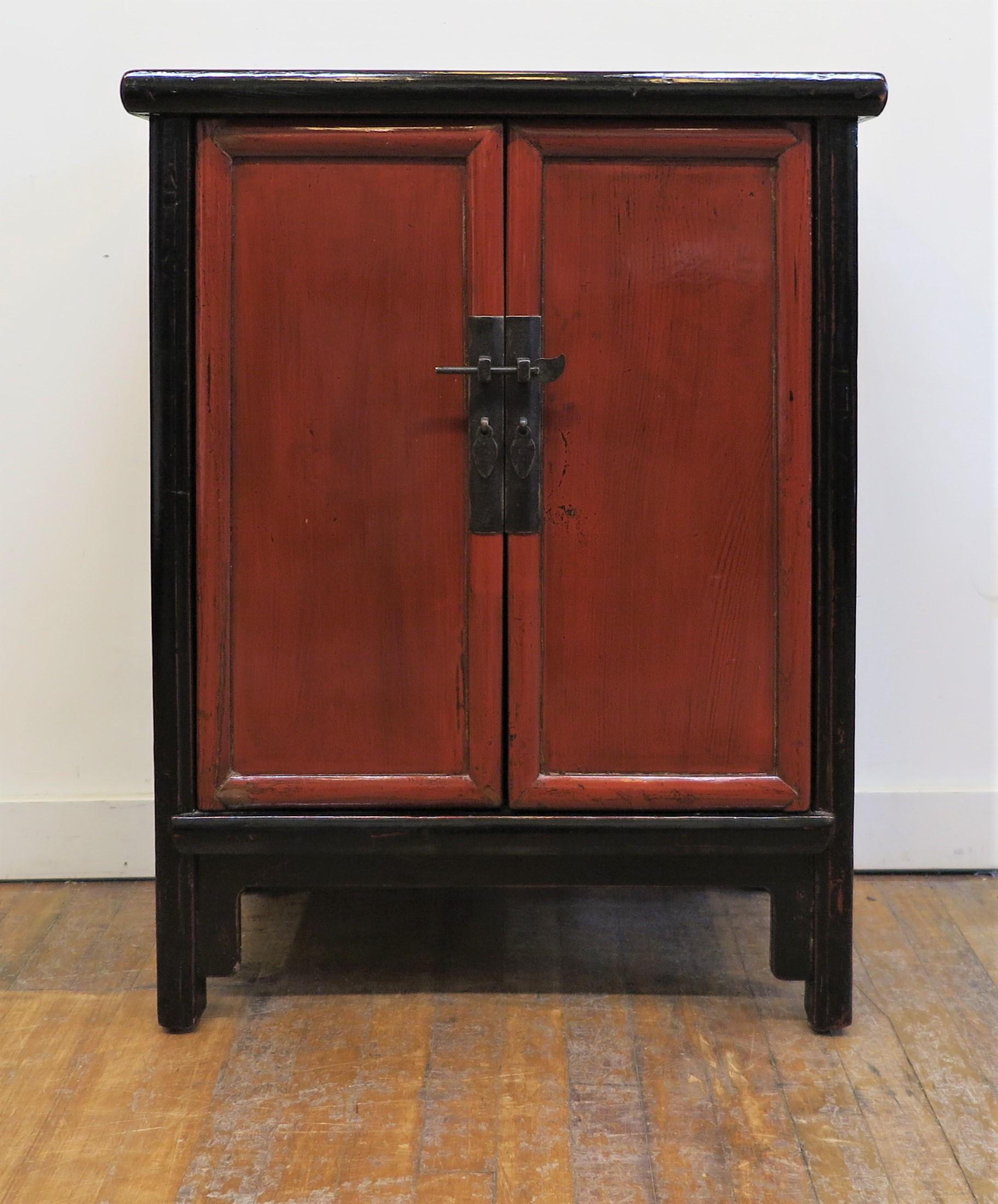 Chinese side cabinet with classic black and red Lacquer. Richly lacquered Black the color of authority power and strength for the sides and top. The doors a perfect Cinnabar red the color of good fortune, happiness and success as believed by Chinese