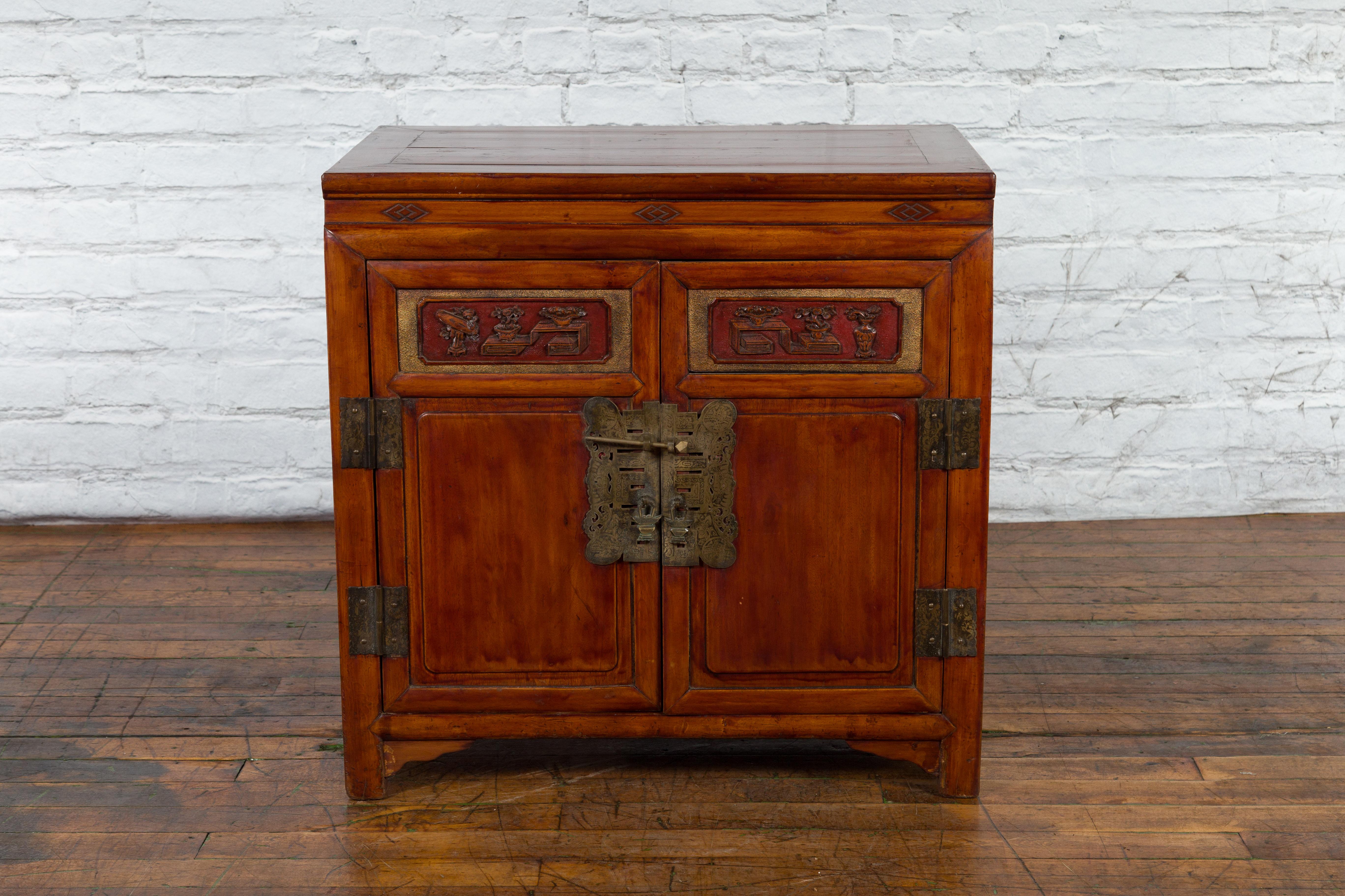 20th Century Antique Chinese Side Cabinet with Carved Panels, Gilt Accents and Hidden Drawers For Sale
