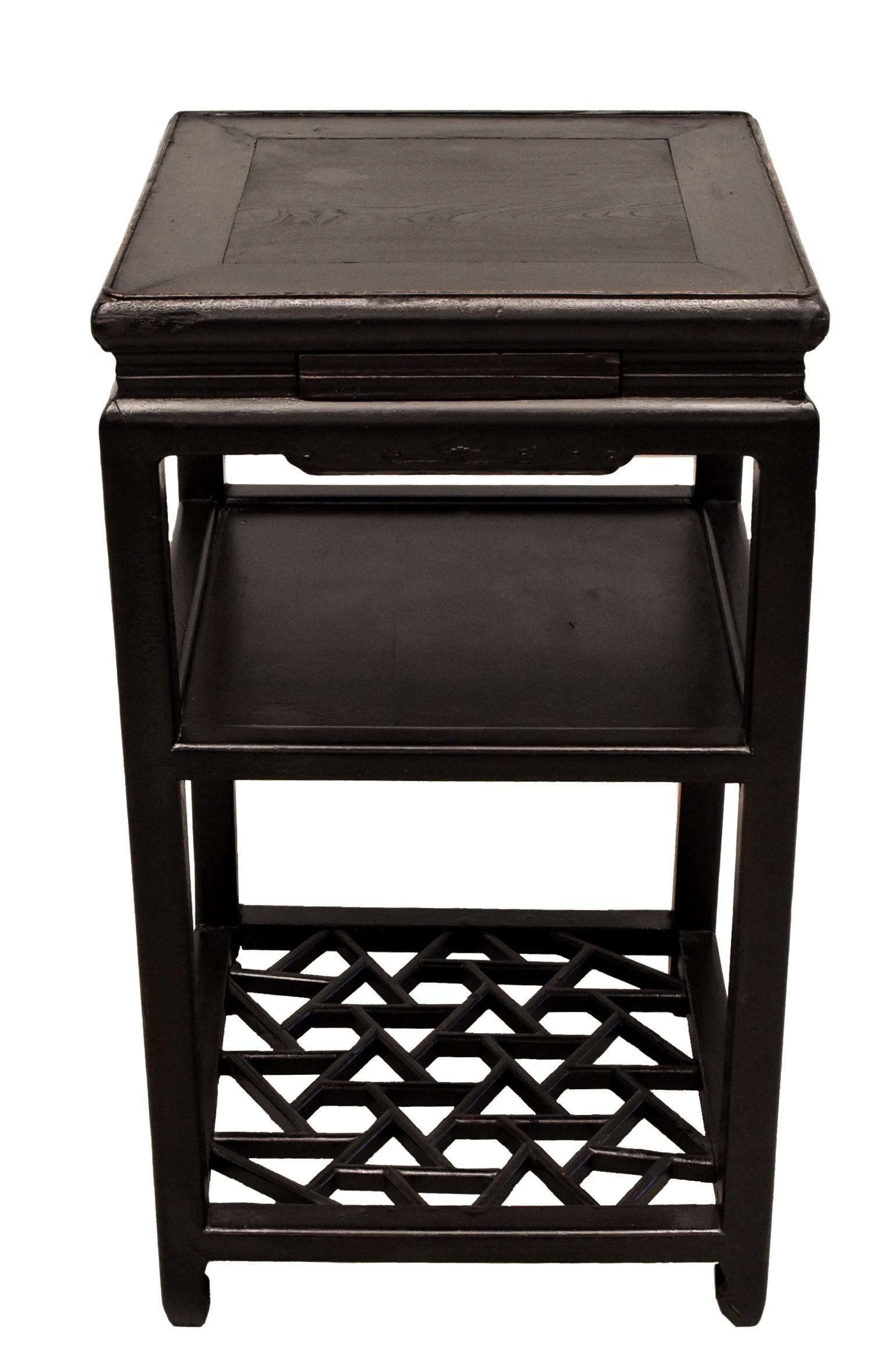 A beautiful Chinese antique side table in dark brown black finish. The table has a top with delicately carved rim, an elegant waist, a solid mid shelf and fantastic ice crackle patterned base that is constructed by joining cuts of wood with tenons