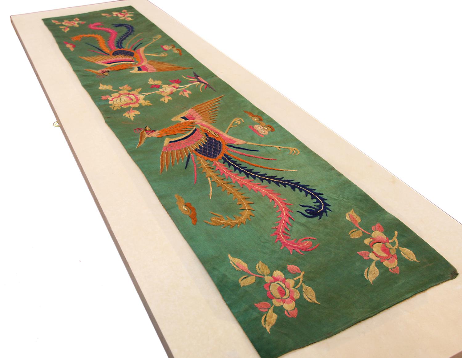 This is an antique Chinese silk textile woven during the end of the 19th century circa 1880 and measures 141x 33CM in size. the design of this textile is centered with a blossoming flower shrub flanked powered by phoenix’s is on each side set on a