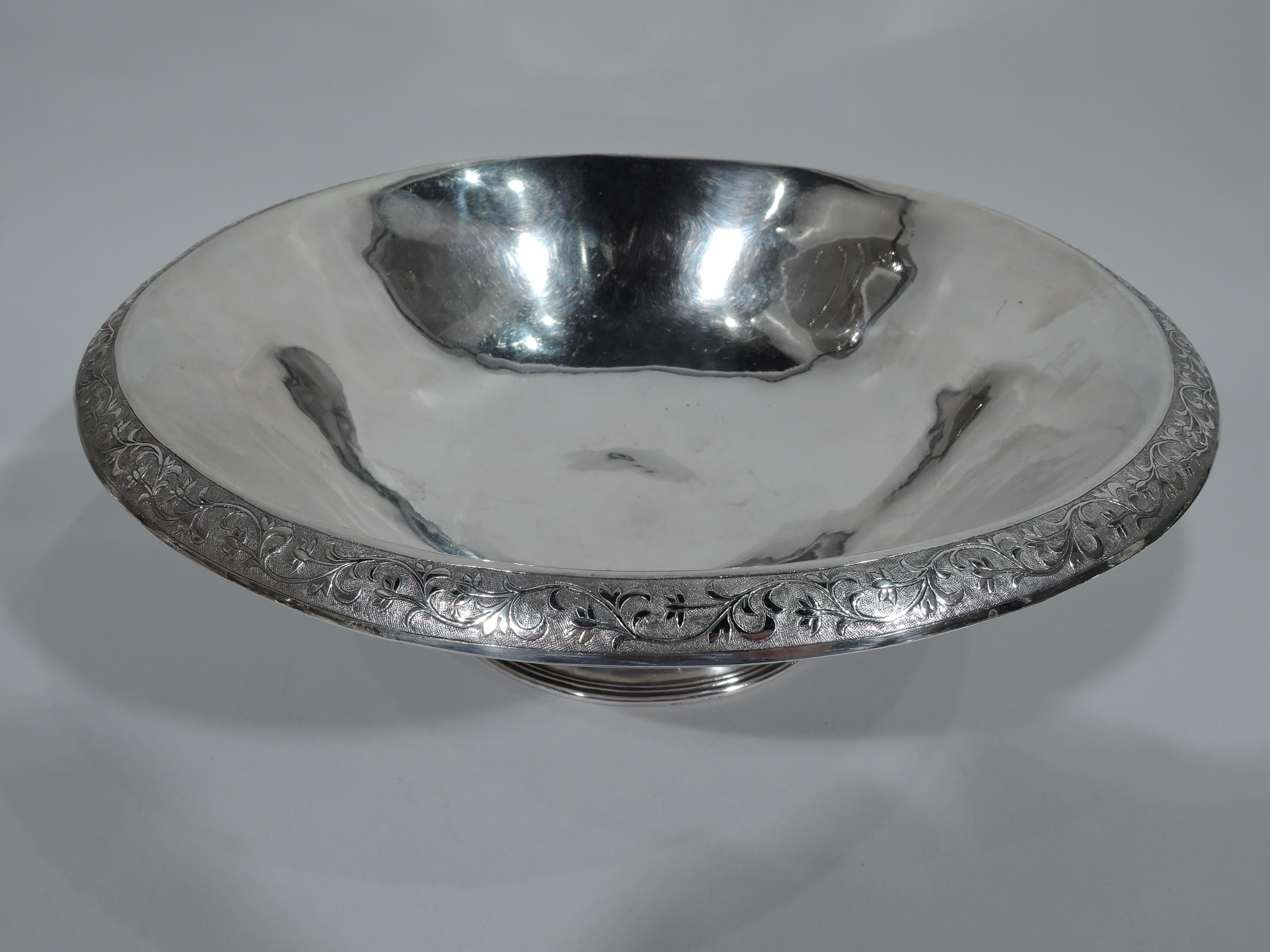 Chinese Export silver bowl, circa 1900. Curved and tapering with spread and reeded foot. Rim turned-down with chased scrolling and leafing branch on stippled ground. Chinese marks. Weight: 18.4 troy ounces.