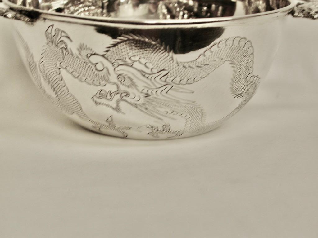 Antique Chinese silver bowl with two double dragon handles circa 1900
Made by Kwan Wo of Canton and Hong Kong with dragon engraved on one side and with 3 chinese characters on the other.
These depict 