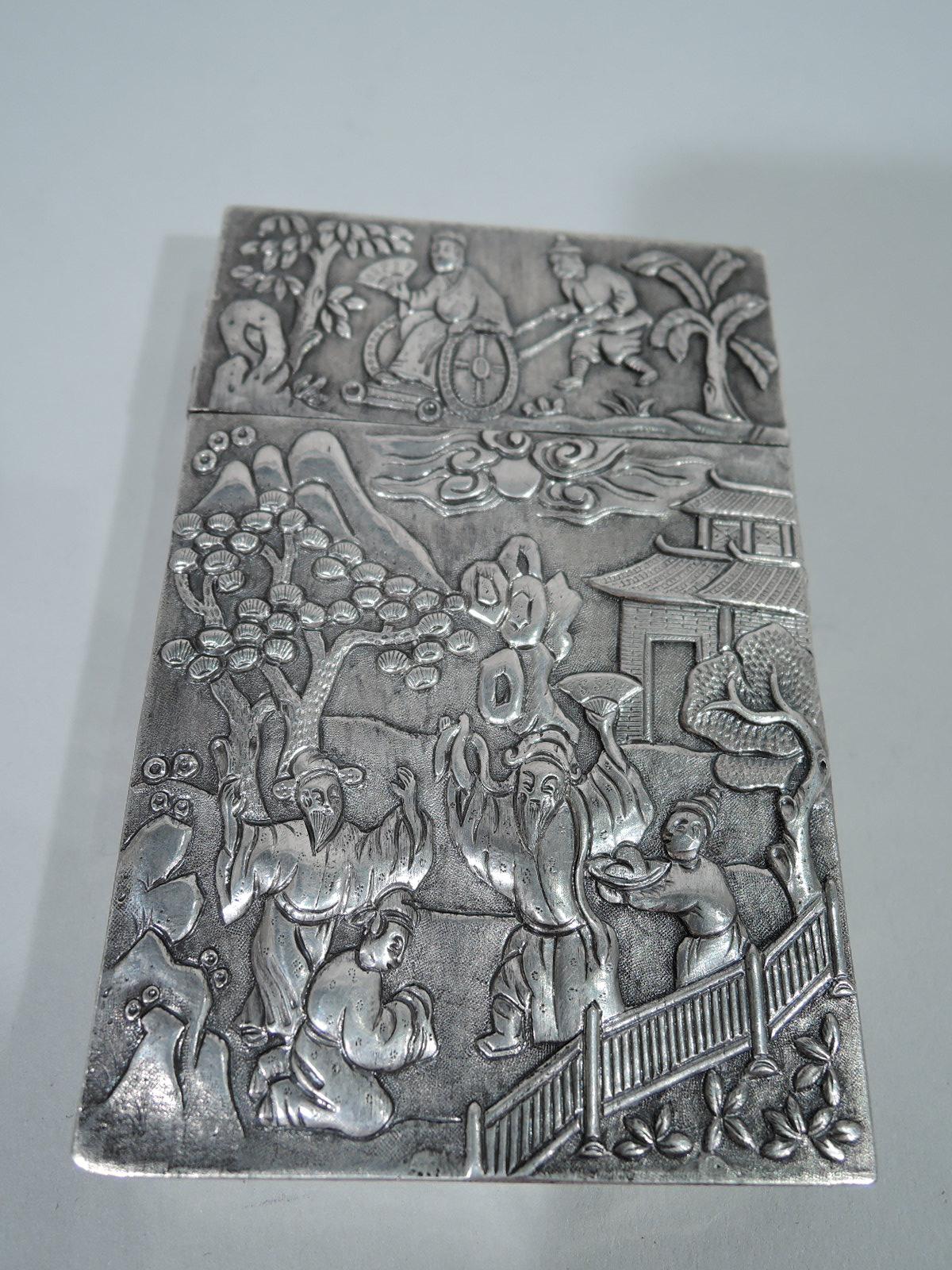 Chinese export silver card case. Narrow and rectangular with straight sides and crisp corners. Chased and embossed scenes with modish exotics: Chinamen in funny gowns and hats with pavilions and blossoming trees in background. A real period piece -