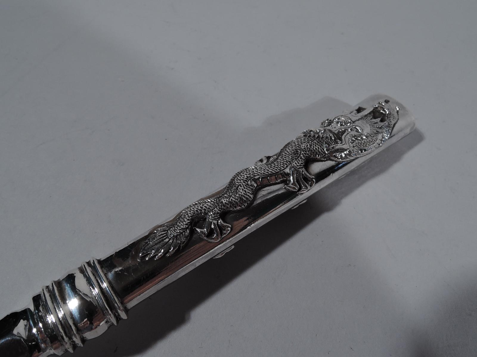 Chinese export silver serving fork, circa 1910. Plain and scalloped 5-tine shank. Handle tapering and hollow with a scary, scaly dragon with slinking talons applied to handle front and back. Marks including stamp for Wang Hing, a noted Hong Kong