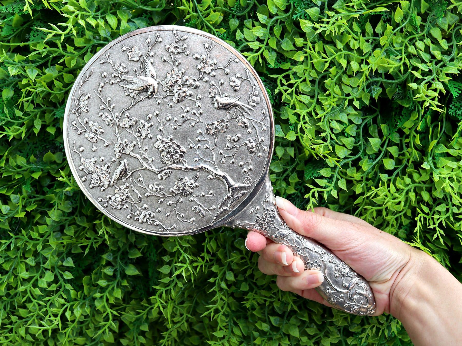 An exceptional, fine and impressive antique Chinese silver dressing table hand mirror; an addition to our collection of Asian antiques.

This exceptional antique Chinese export silver (CES) hand mirror has a circular form with a rounded handle.

The