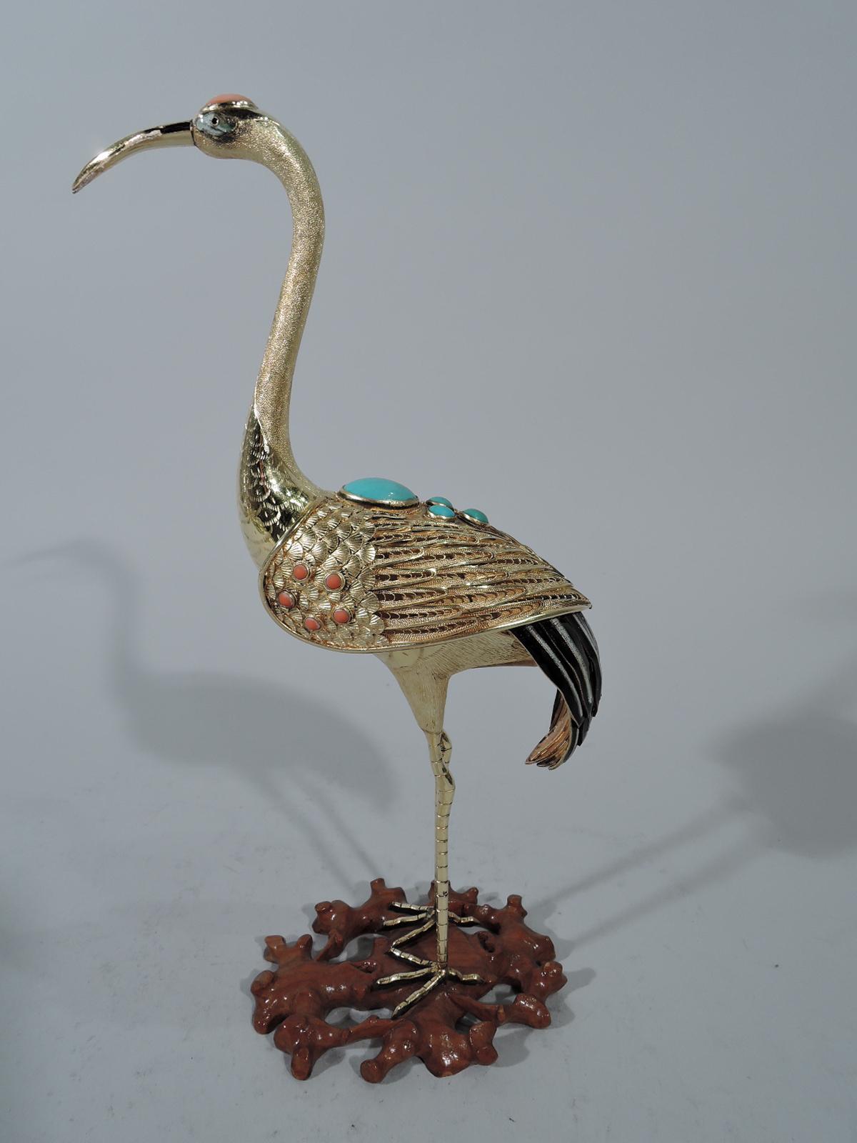Antique Chinese silver gilt bird figure, early 20th century. A crane with S-scroll neck and long pointed bill and round body stands on spindly legs and talon feet mounted to carved rosewood base. Applied wings with imbricated fans and feathers. Tail