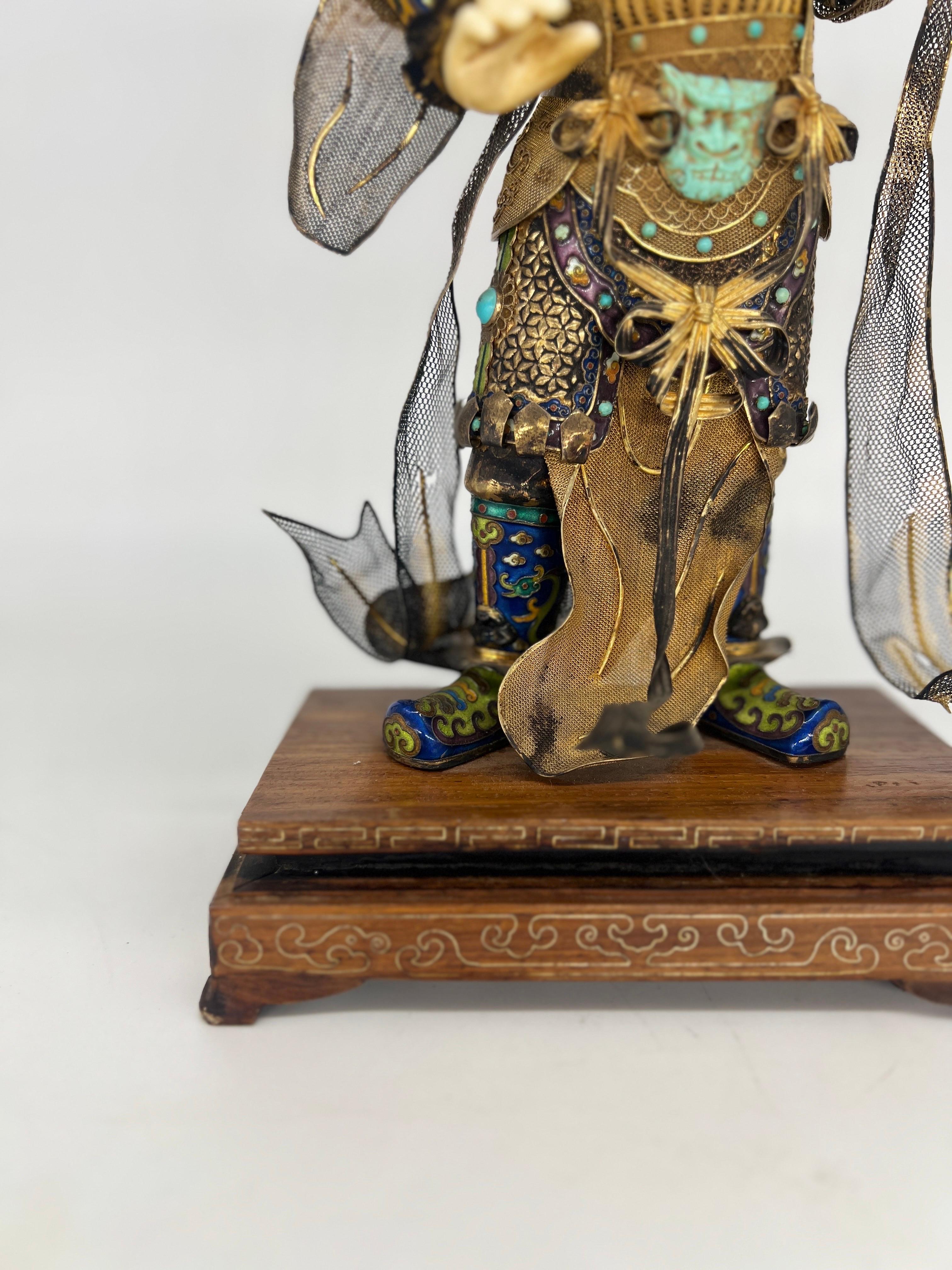 Antique Chinese Silver Gilt, Enamel & Turquoise Mounted Immortal Figurine. 
A very fine Chinese immortal figurine constructed using vermeil sterling silver intricately layered and fanned across the body. Each element of the body is covered in