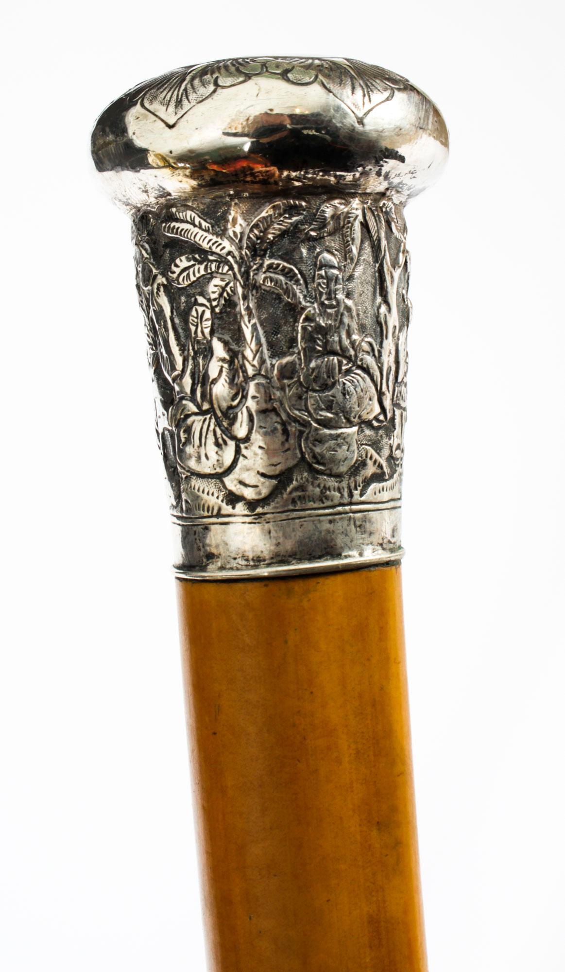 This is a beautiful antique gentleman's silver pommel and Malacca shaft Chinese walking stick, circa 1880 in date.

This decorative walking cane features an exquisite Chinese silver pommel decorated with exquisitely cast Chinese figures in a tree