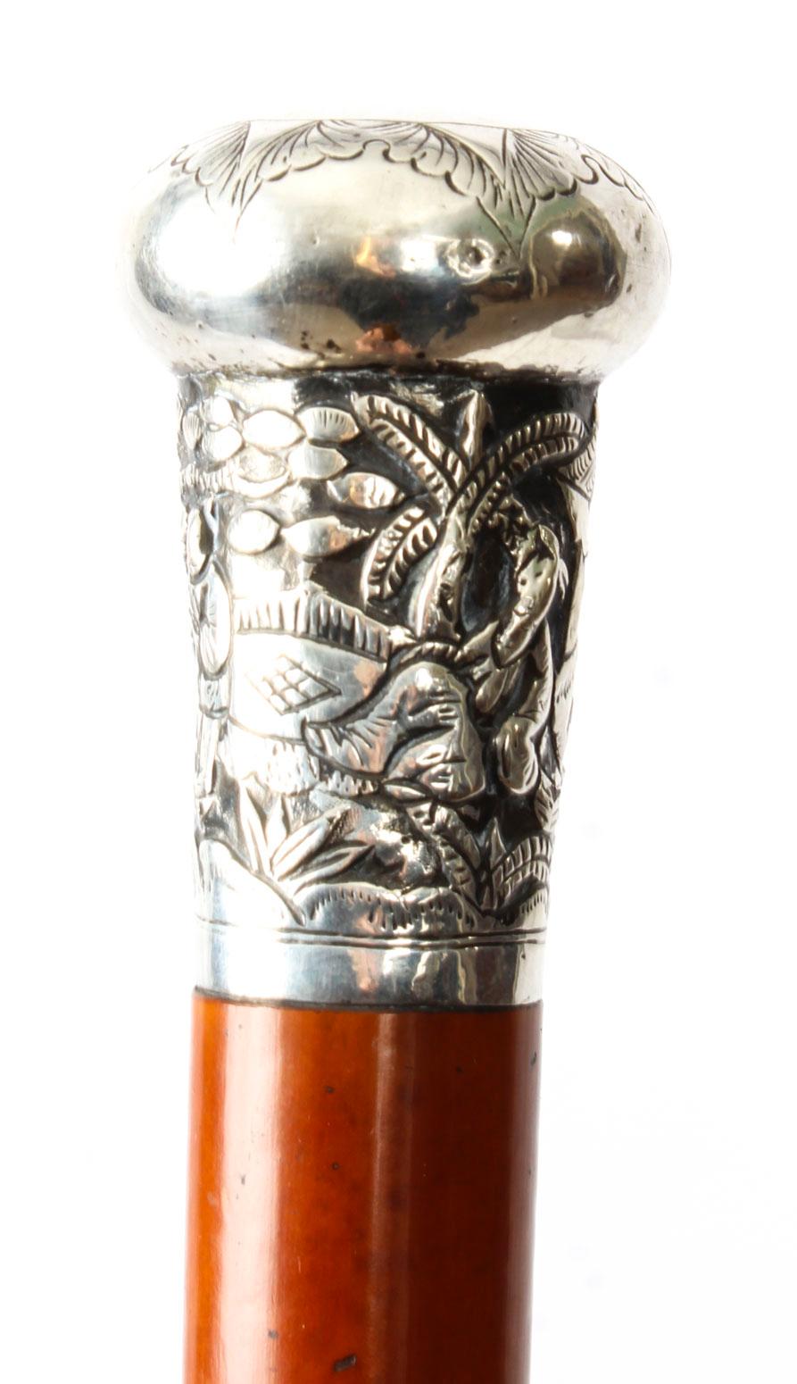 This is a beautiful antique Chinese gentleman's silver pommel walking stick, late 19th century in date.

It features an exquisite Chinese silver pommel decorated with figures in a wooded landscape. The Malacca shaft is complete with its original