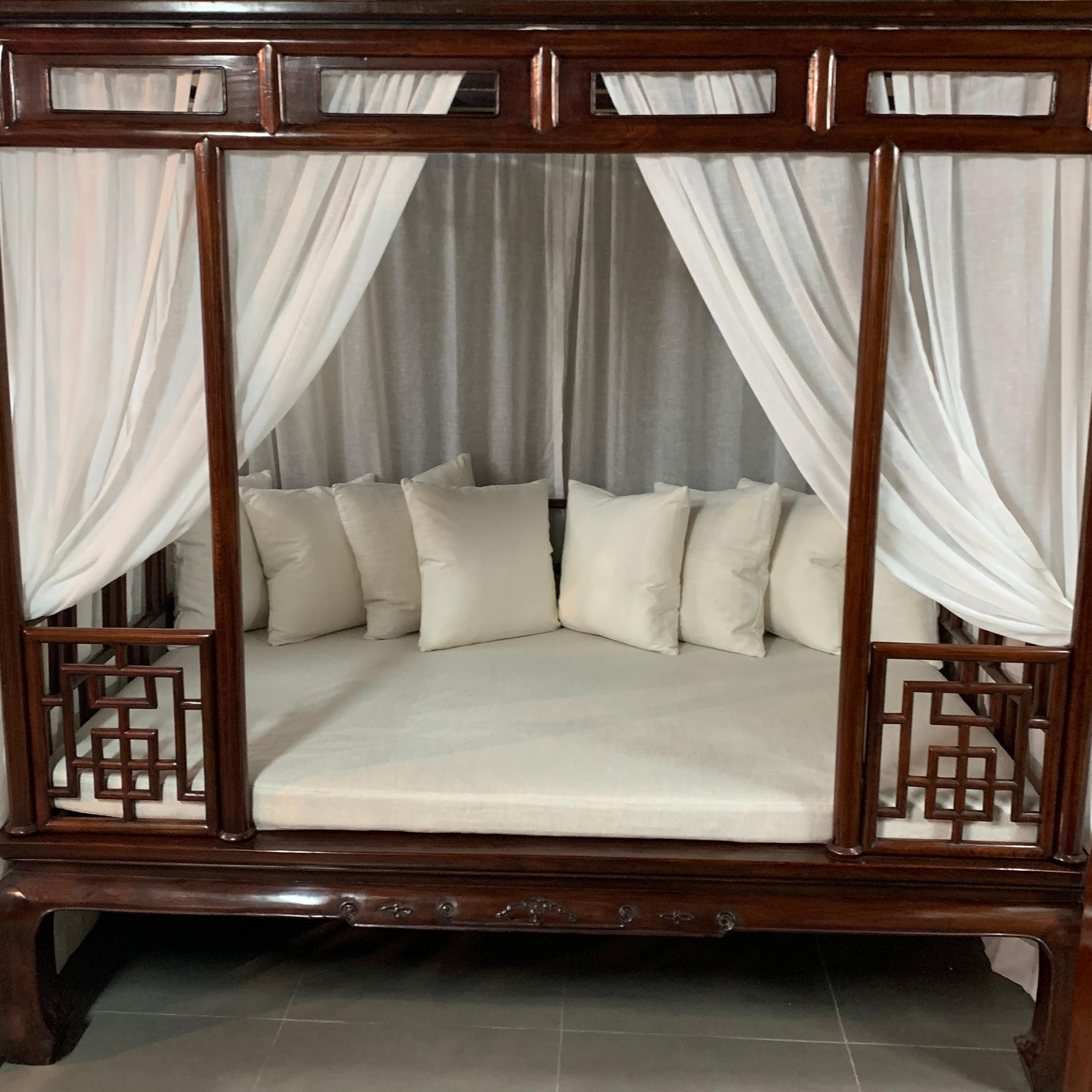 The bed base with a waist, ice-plate edged frame enclosing a cane top, slightly convex aprons with relief-carving and beading continuing to the horse hoof feet, six posts forming the frame for the railings and canopy, decorated with fretwork of