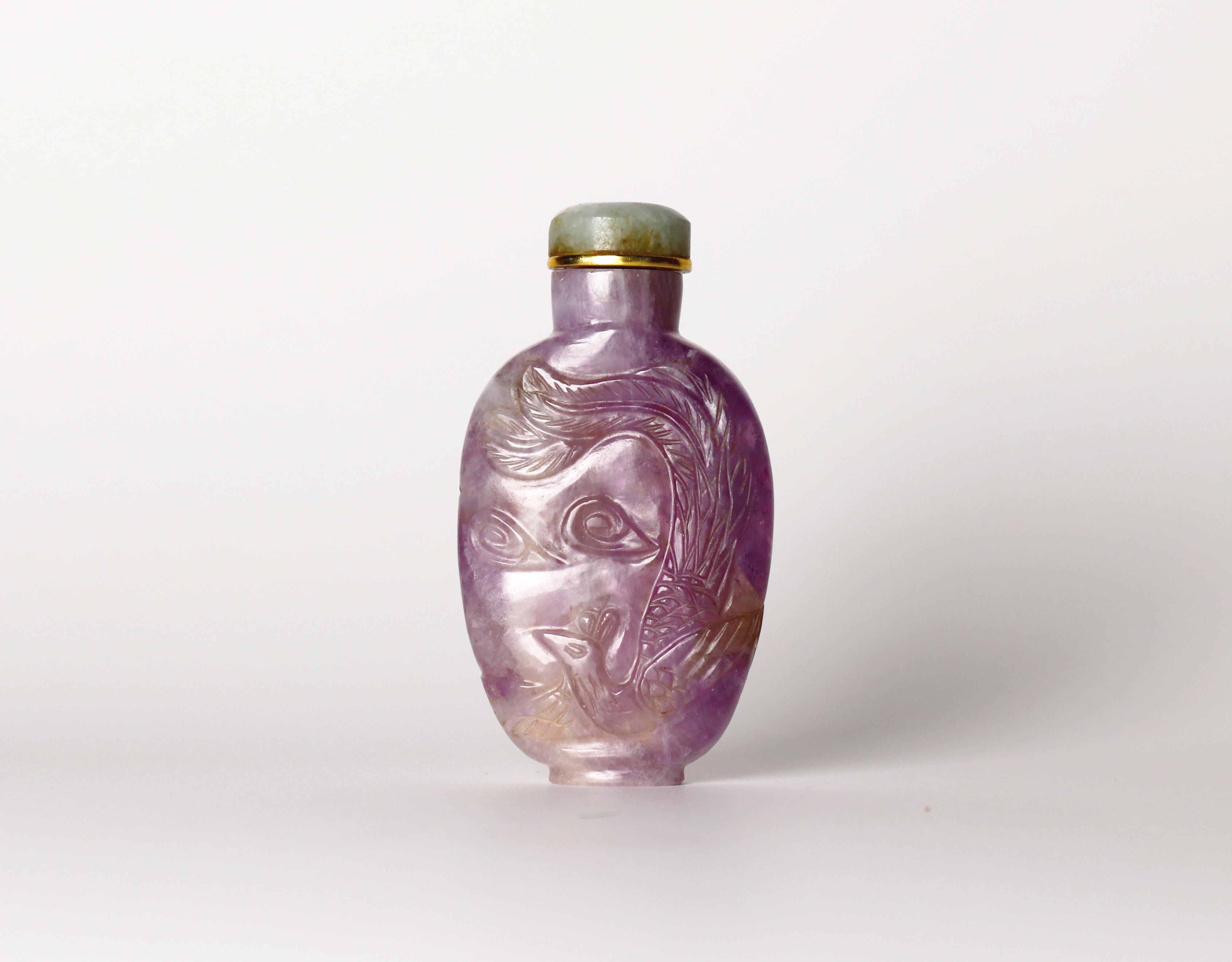 Antique late Qing hand carved amethyst snuff bottle.

Produced in China towards the end of the 19th century.

With an auspicious design featuring a Dragon and Phoenix.

Comes with gilt metal and jadeite stopper (no spoon)

In very good antique