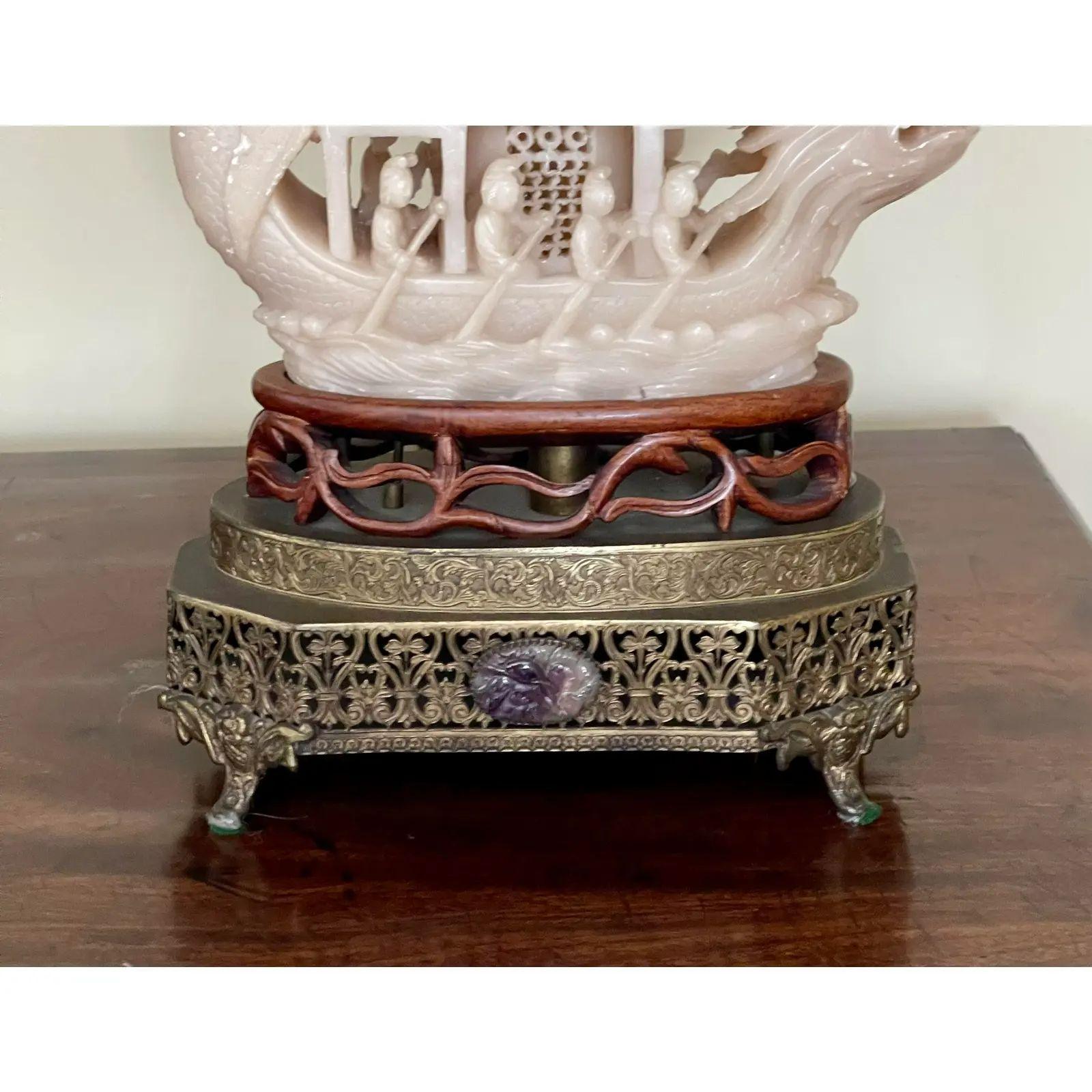 Antique Soapstone ship sculpture Now a designer table lamp. It is beautifully carve and features figures rowing a large ship. It includes the custom shade illustrated as well as a beaded pull.

Additional information: 
Materials: Lights, Silk,