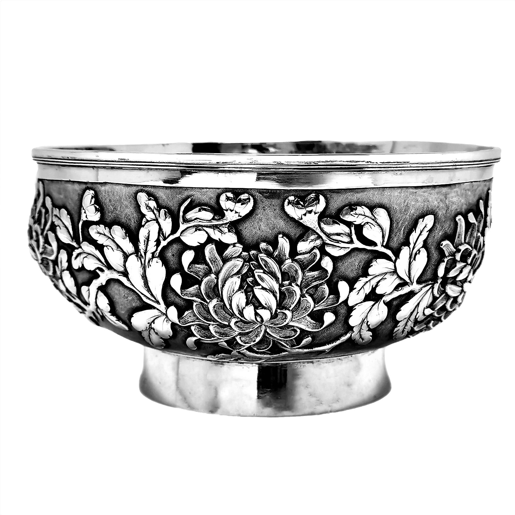 A beautiful Antique 19th Century Chinese Silver Bowl embellished with deeply chased stylised chrysanthemums around the entire body of the bowl. The Bowl stands on a round foot.

This Bowl was made in c. 1890 in Shanghai, China by important Chinese