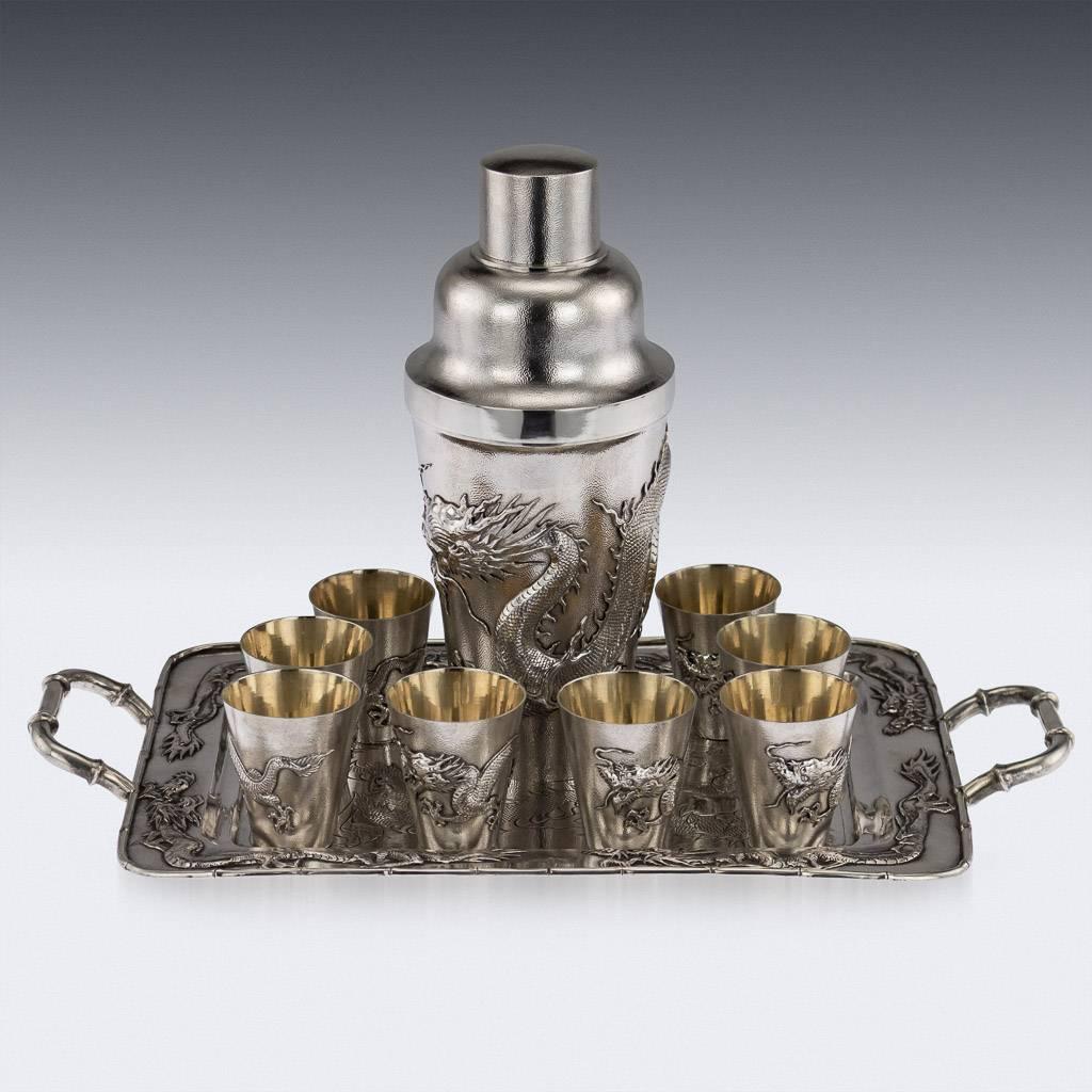 Antique 20th century Chinese Export solid silver cocktail set on tray, shaker of tapering cylindrical form, beautifully applied with a dragons on matted ground, extraordinary quality of workmanship. The shaker has a domed detachable upper portion