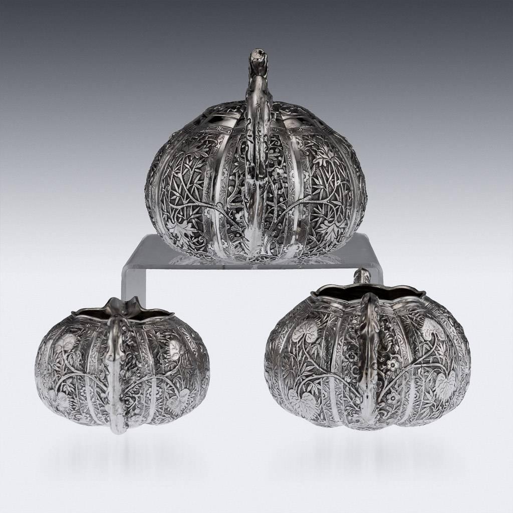 Antique 19th century Chinese Export solid silver three-piece tea set, comprising of a teapot, sugar bowl, milk jug, each melon shaped body is beautifully chased with bamboo leaves, flowers and people in landscapes on a matted ground, each piece