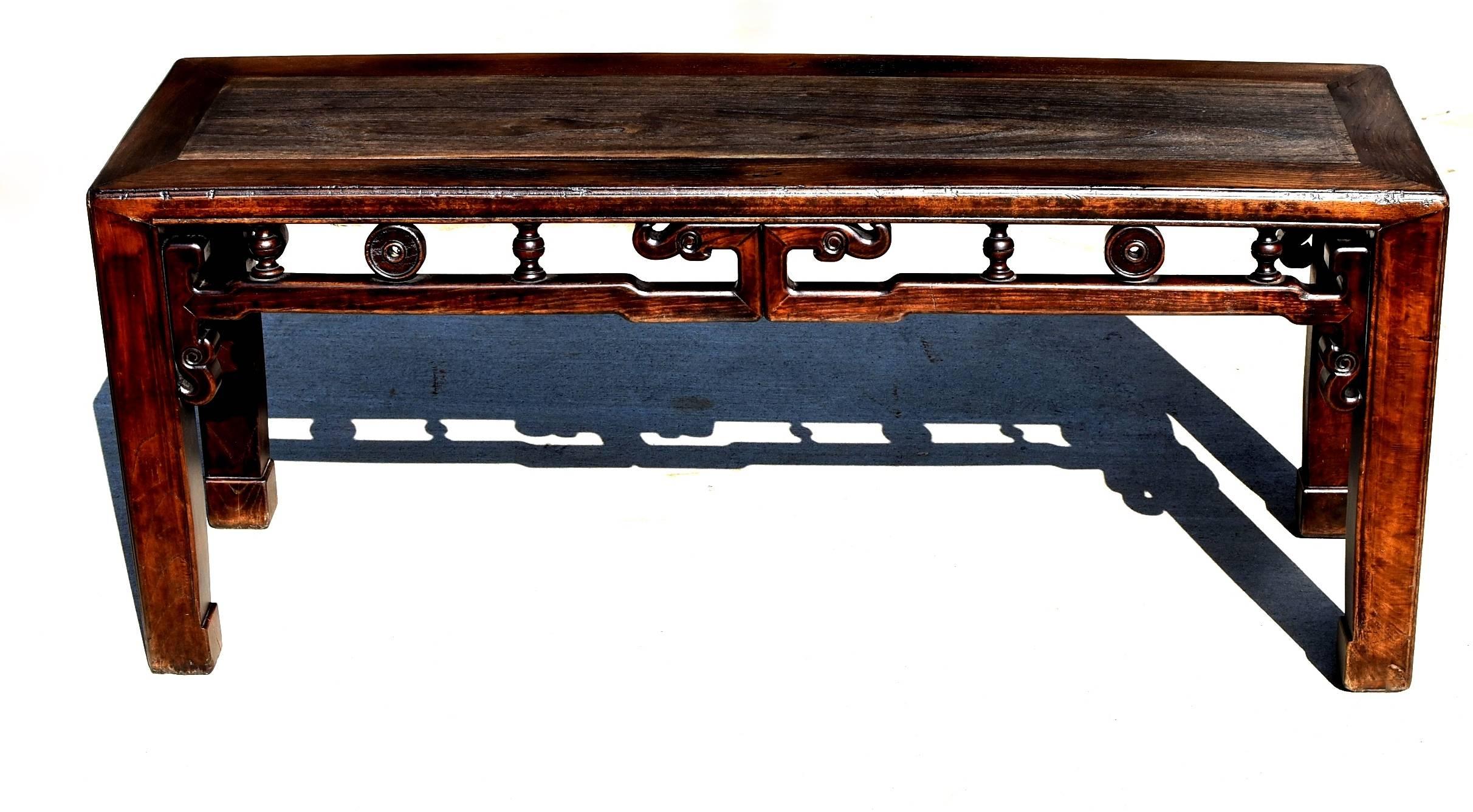 A solid wood antique Chinese spring bench.

Such a bench was made in the region south of China's Yangtze River. It is sturdy and multi-functional, often used both as seating and a table. The bench is finished on all sides, featuring the