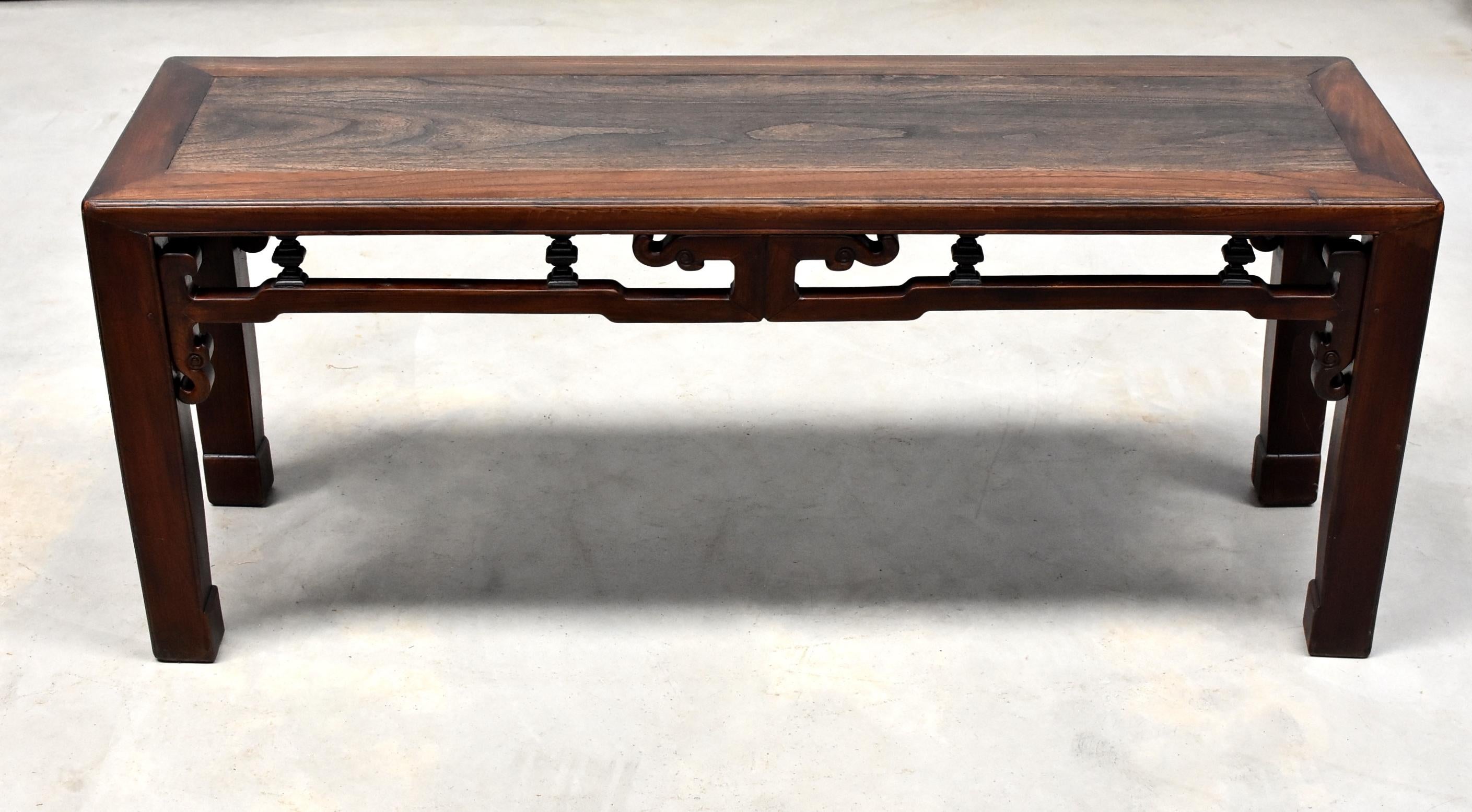 A solid wood antique Chinese spring bench. Such a bench was made in the region south of China's Yangtze River. It is sturdy and multifunctional, often used both as seating and a table. The bench is finished on all sides, featuring the traditional